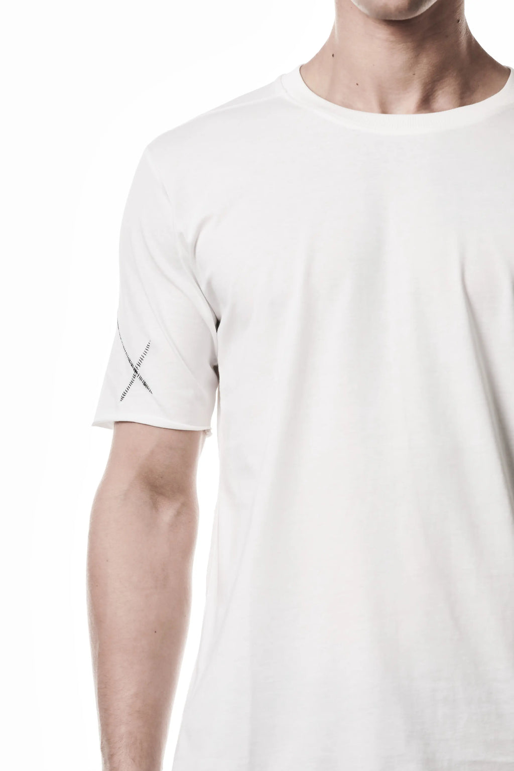 Thom Krom, Mens T-Shirt, Off-White, Raw-Cut Hem, Elastic Neck, 100% Cotton, Short Sleeves, Crewneck, Round Neck, Dark Seams, Back Seams, Embroidered Logo, Right Sleeve Fit Close-up. 