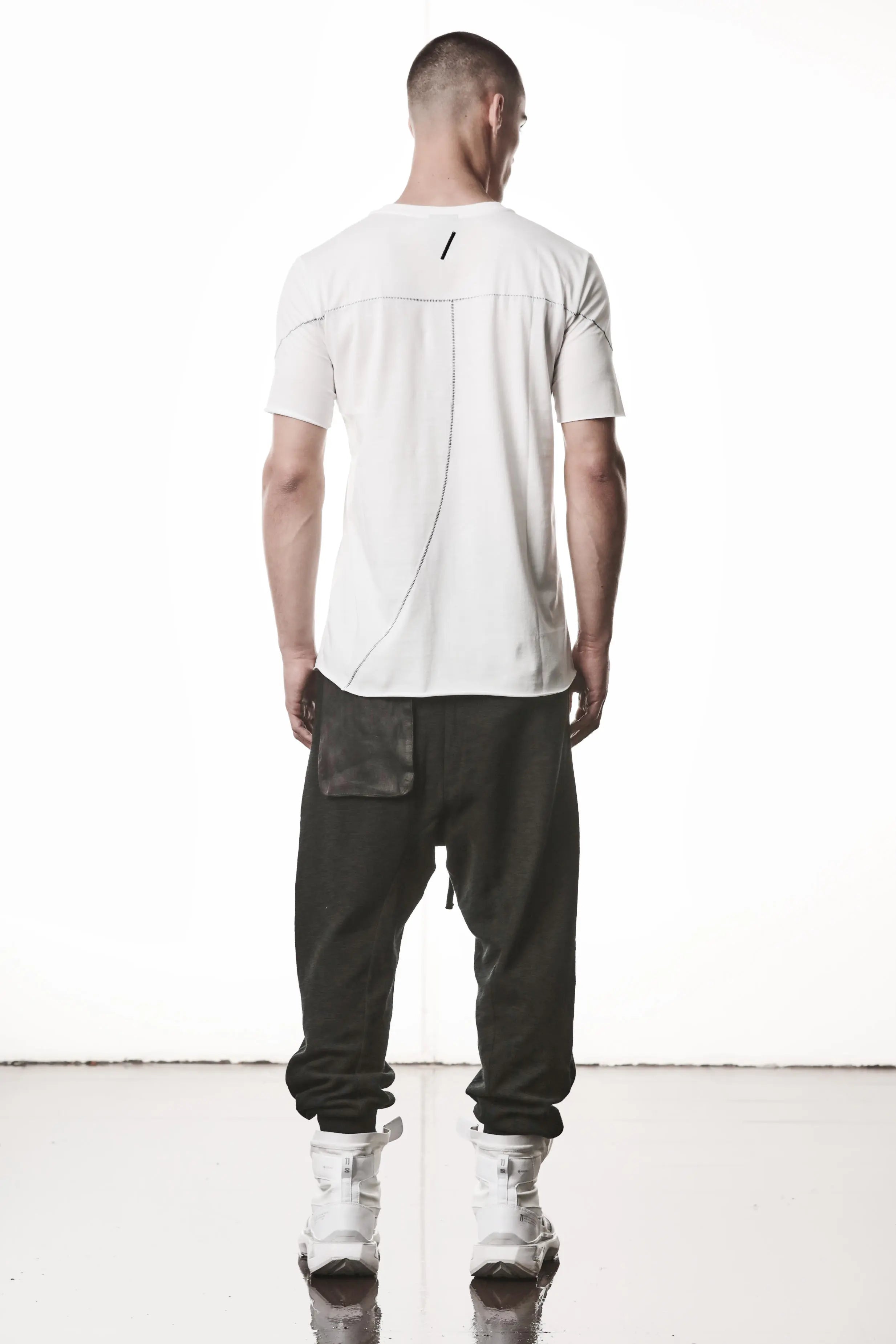 Thom Krom, Mens T-Shirt, Off-White, Raw-Cut Hem, Elastic Neck, 100% Cotton, Short Sleeves, Crewneck, Round Neck, Dark Seams, Back Seams, Embroidered Logo, Back View. 