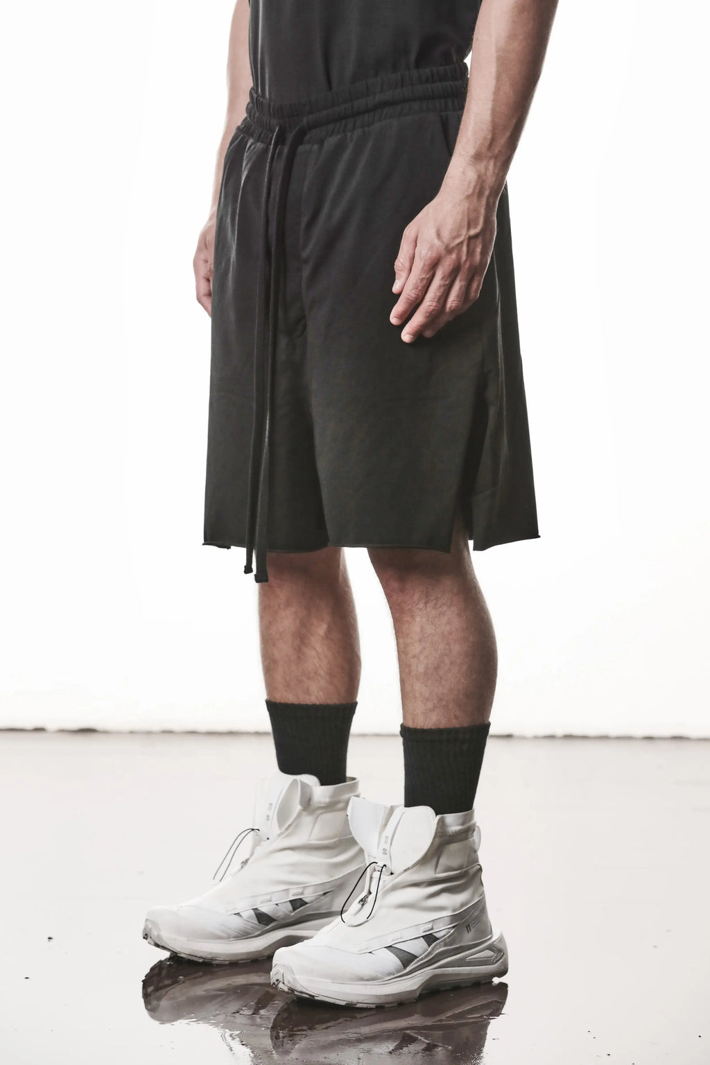 Thom Krom, Mens Shorts, Black, Stretch Cotton, Cotton-Elastane Blend, Spandex, Elasticated Waistband, Drawstring, Side Pockets, Raw-Cut Side Slits, Front 3/4 View. 