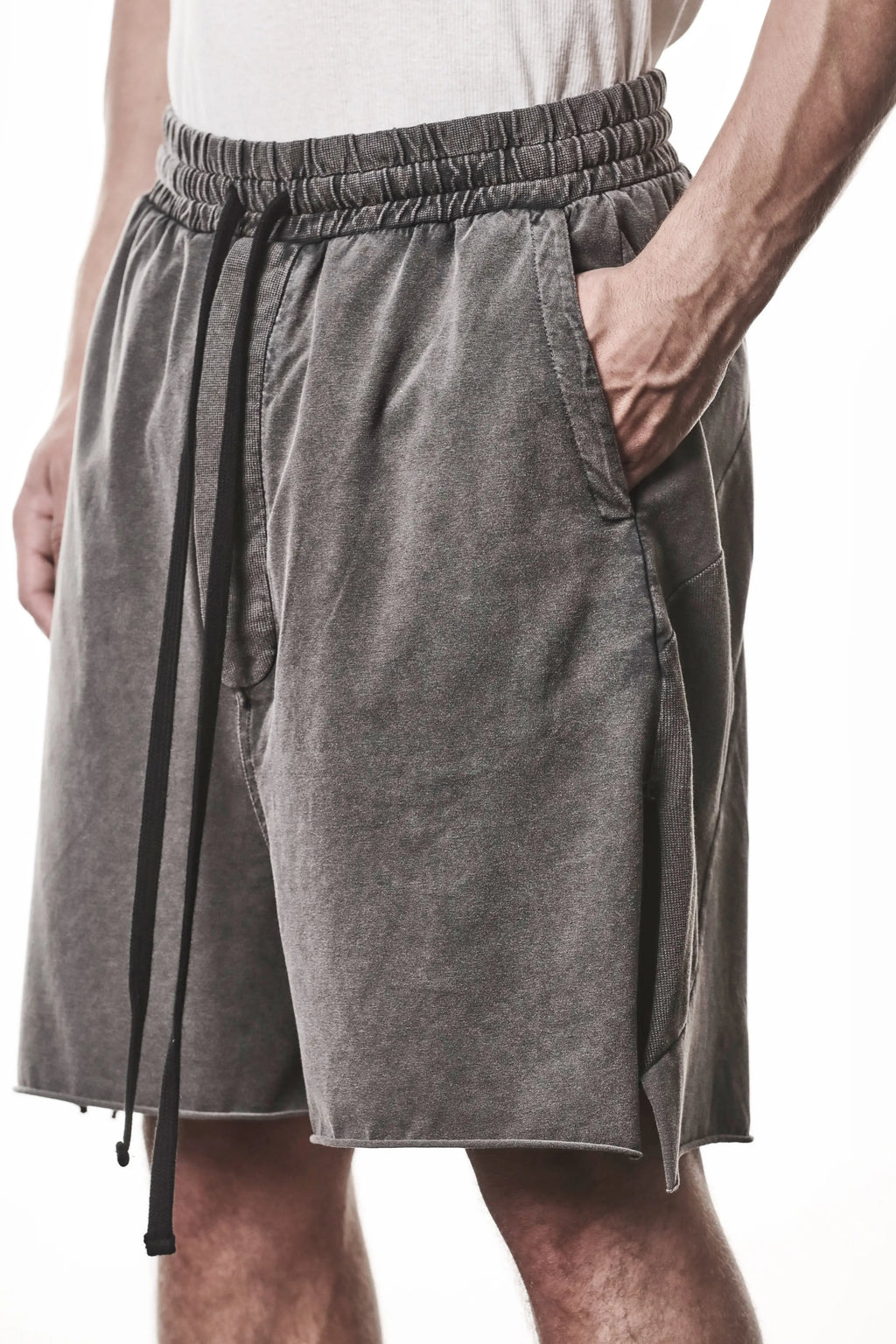 Thom Krom, Mens Shorts, Dark Used Grey, Stretch Cotton, Cotton-Elastane Blend, Spandex, Elasticated Waistband, Drawstring, Side Pockets, Raw-Cut Side Slits, Hand in Pockets Close-up. 