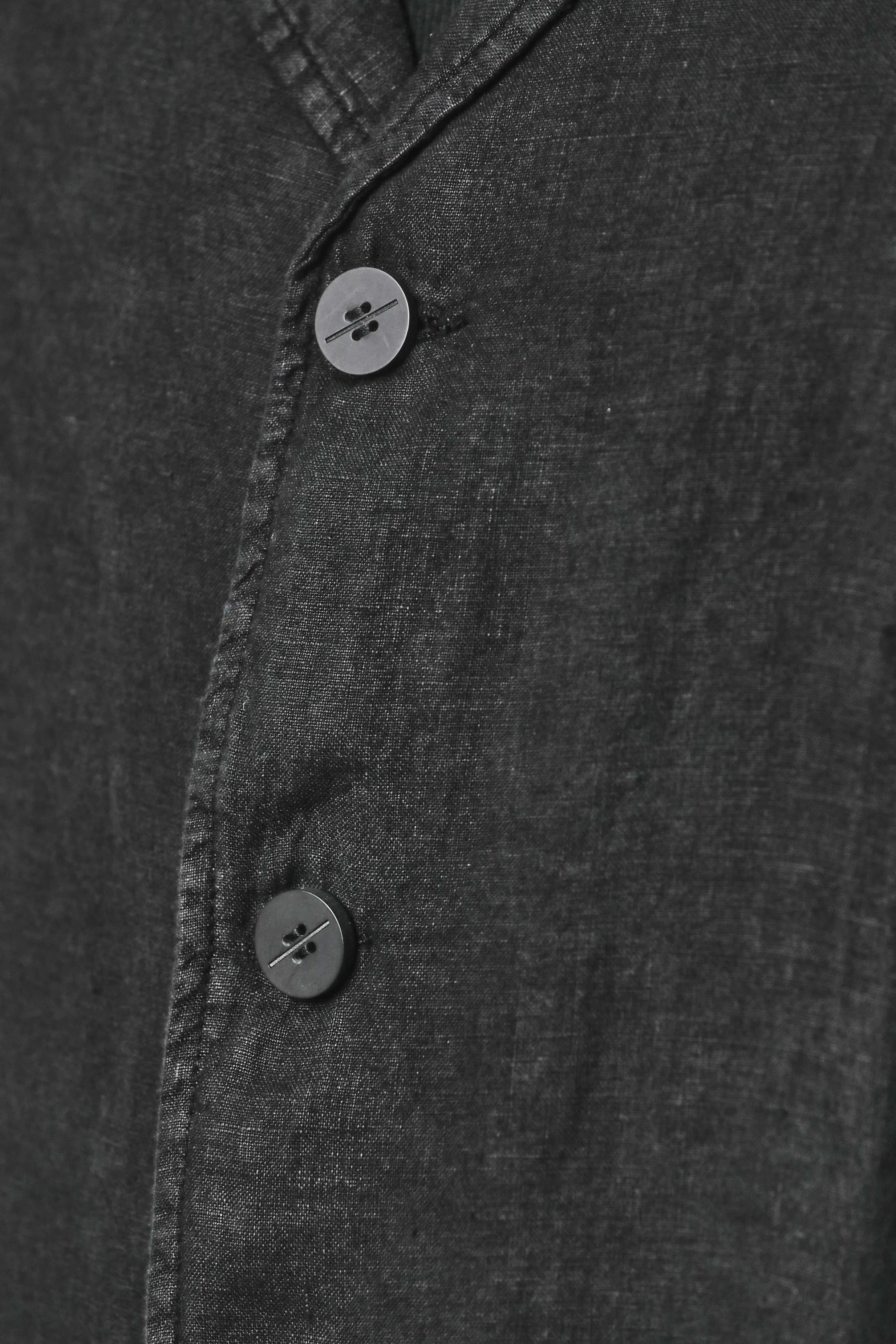 Thom Krom, Mens Blazer, Black, 100% Linen Shell, Cotton & Polyester/Viscose Linings, 3-button closure, Flap Pockets, Hidden Inner Pockets, Relaxed Detailing, Woven Fabric, 2/3 Buttons Close-up. 