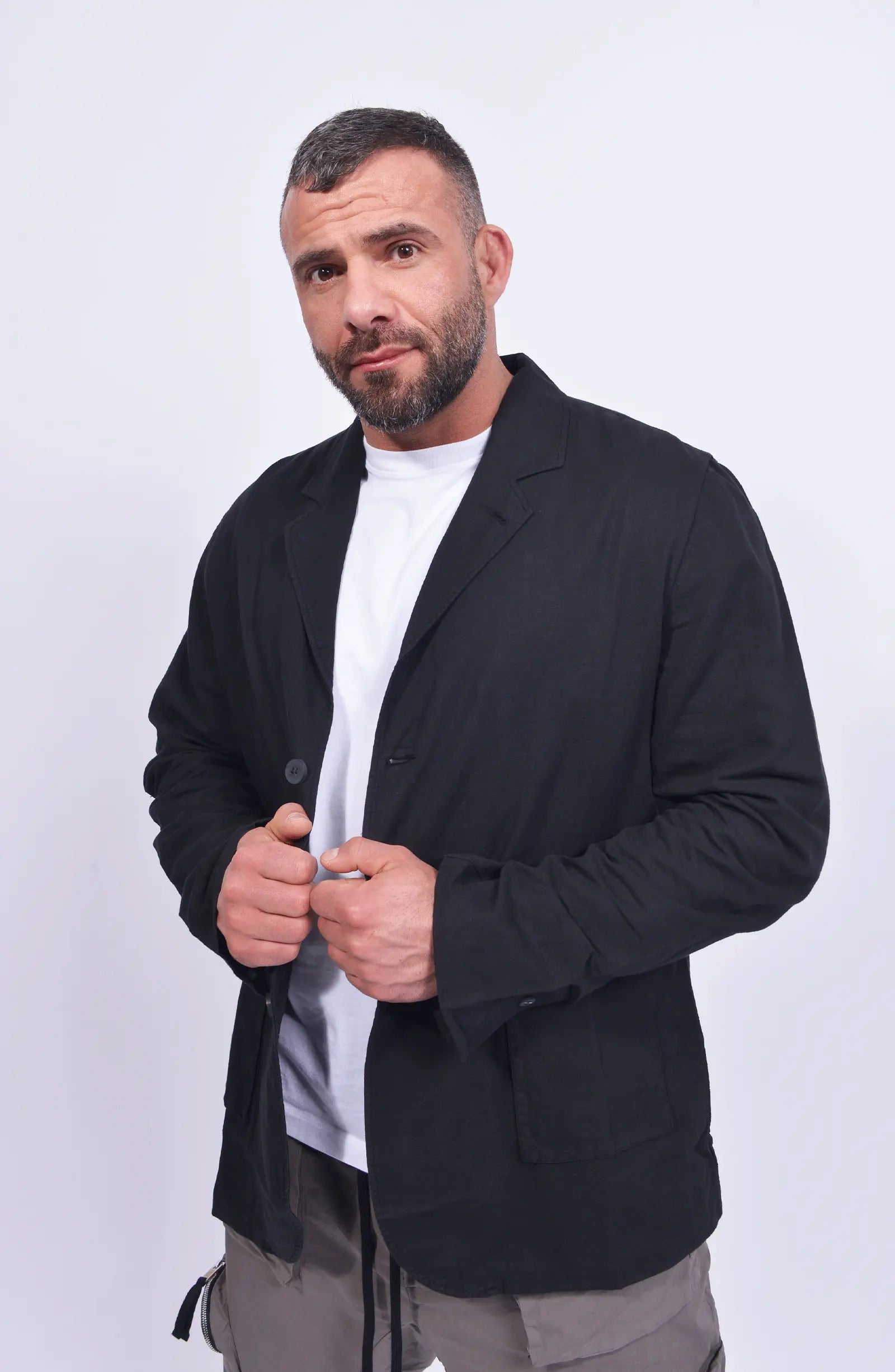 Thom Krom, Mens Blazer, Black, Buttons, V-Neck, Collar, Patch Pockets, Long Sleeves, White T-Shirt, Side Pockets, Slit in Back, Woven, Front View Hands in Front. 