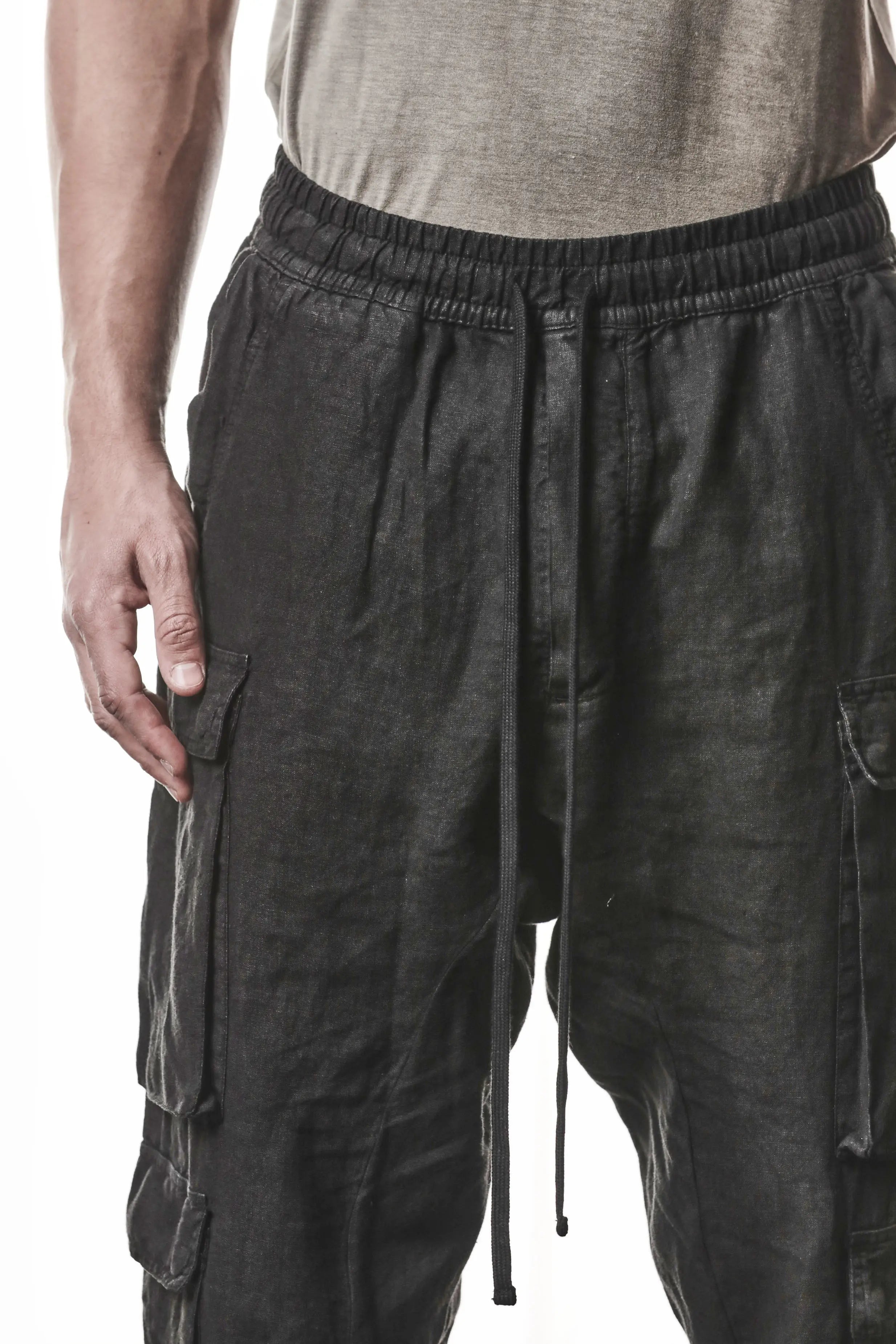 Thom Krom, Mens Pants, Black, Linen, Elasticated Waistband and Cuffs, Low-Crotch Trousers, Cargo Details, Black Drawstring, Side Pockets, Back Pockets, Front View Close-up. 