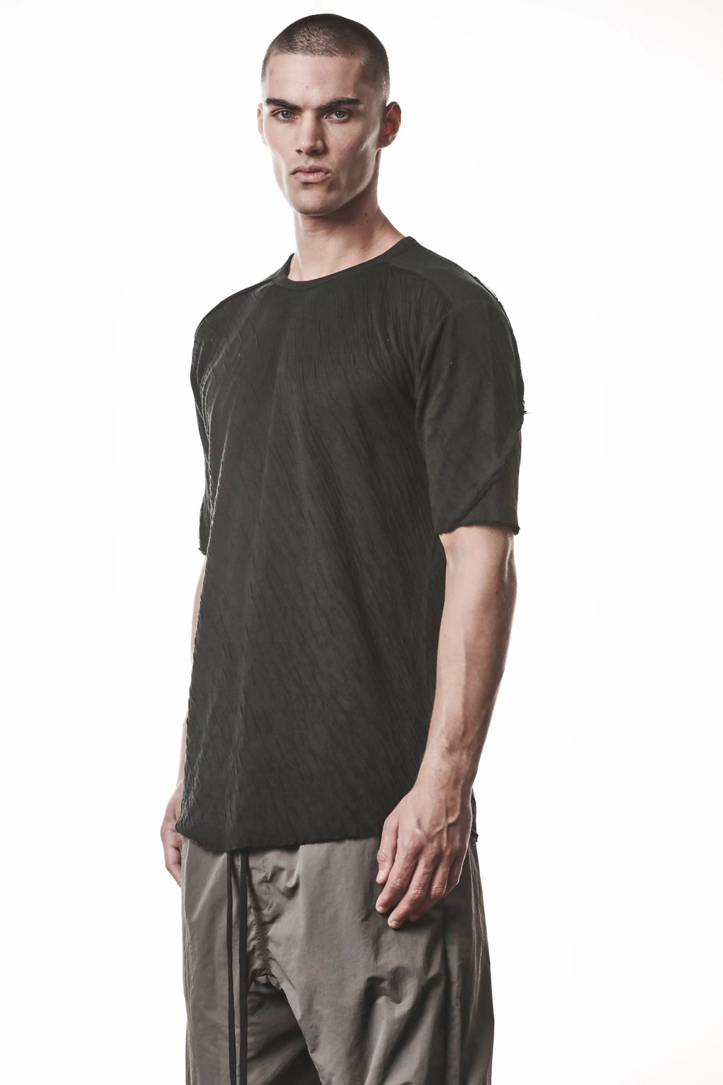 Thom Krom T-Shirt,Mens T-Shirt,Black Cotton,Raw Cut Hem,Raw Cut Sleeves,Round Crewneck,Slim Fit,Lightweight Crashed Bonded Cotton, Signature Front Level Shoulder Seams,Asymetric Sleeve Seams,Side Angle Upper Body Photo