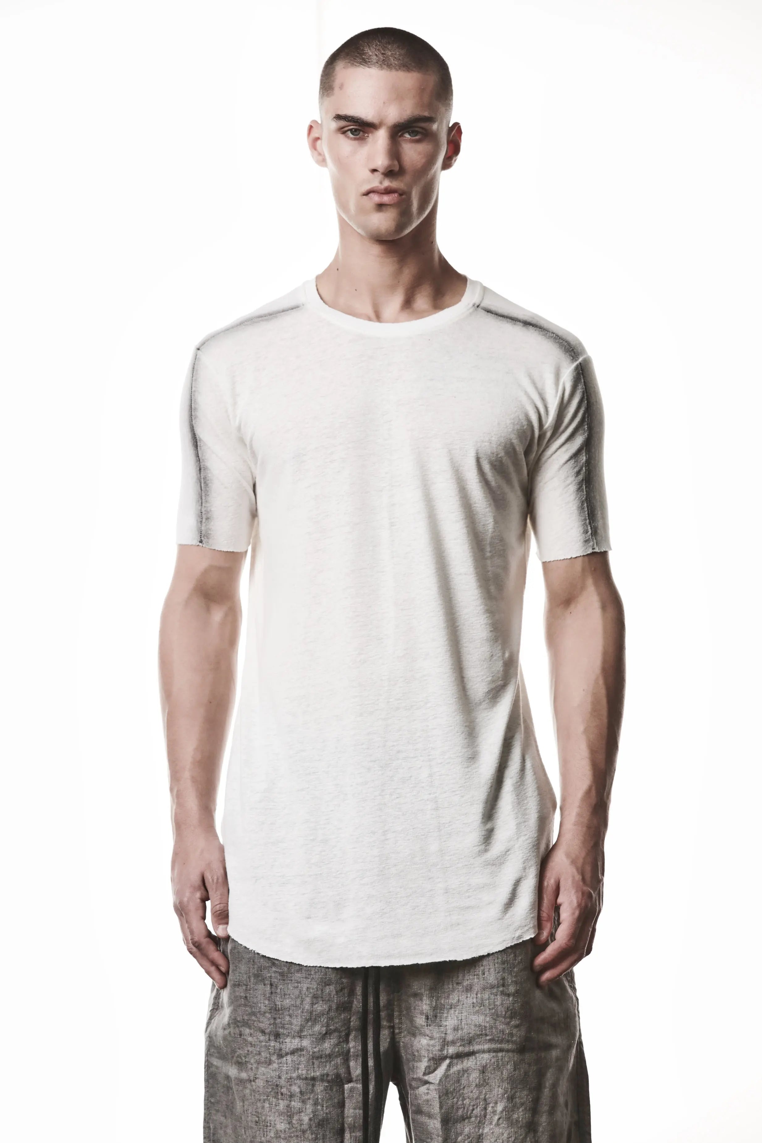 Thom Krom T-Shirt , Mens T-Shirt , Off White Cotton , Raw Cut Hem , Raw Cut Sleeves , Round Crewneck , Slim Fit , Standard Length , Signature Front Level  Shoulders Seams , Vertical Curved Dark Stiching Lines , Half Body Photo , Linen , Viscose , Cotton