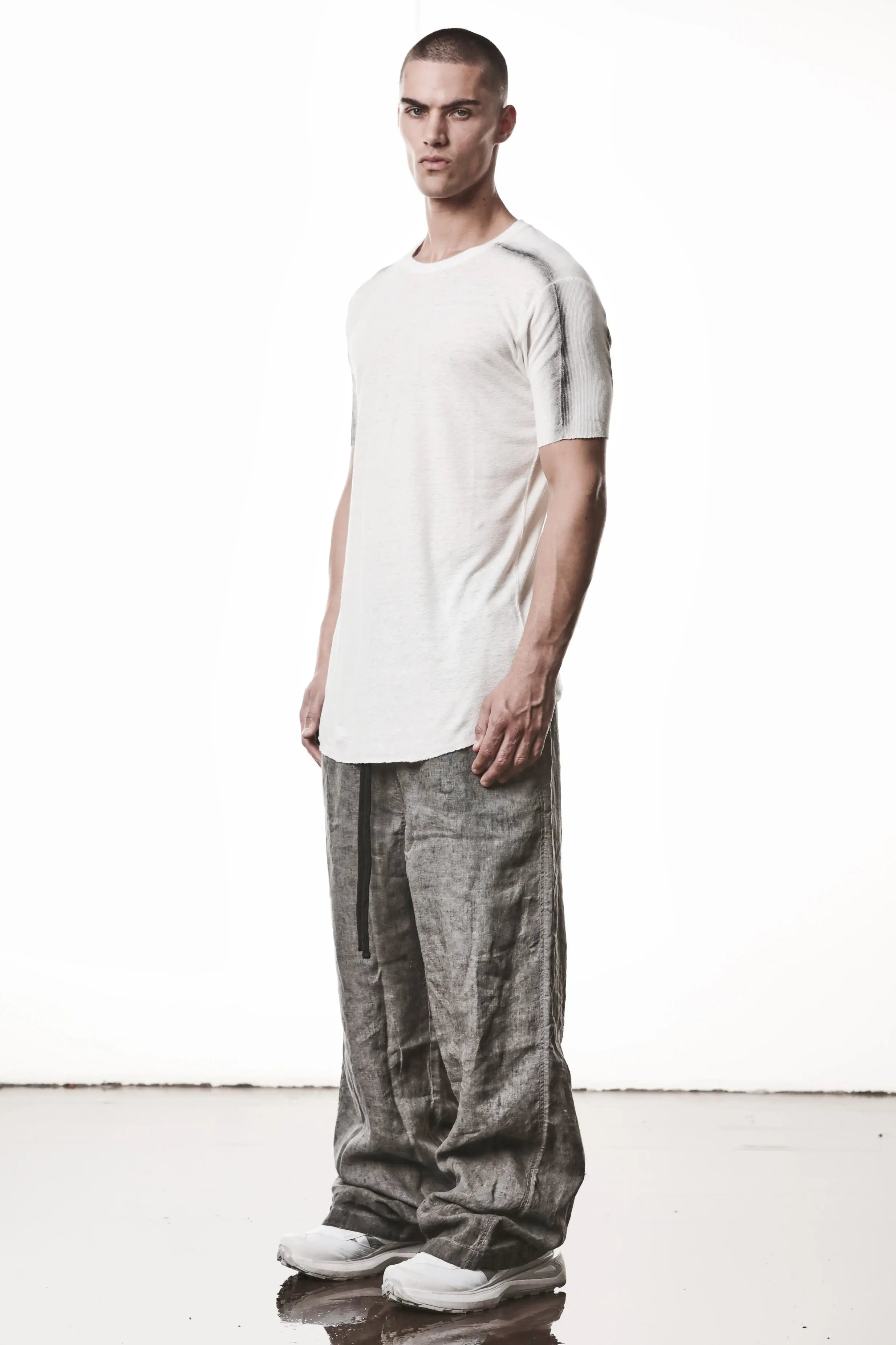Thom Krom T-Shirt , Mens T-Shirt , Off White Cotton , Raw Cut Hem , Raw Cut Sleeves , Round Crewneck , Slim Fit , Standard Length, Signature Front Level  Shoulders Seams , Vertical Curved Dark Stiching Lines , Half Body Photo , Linen , Viscose , Cotton , Side Angle Full Body Photo