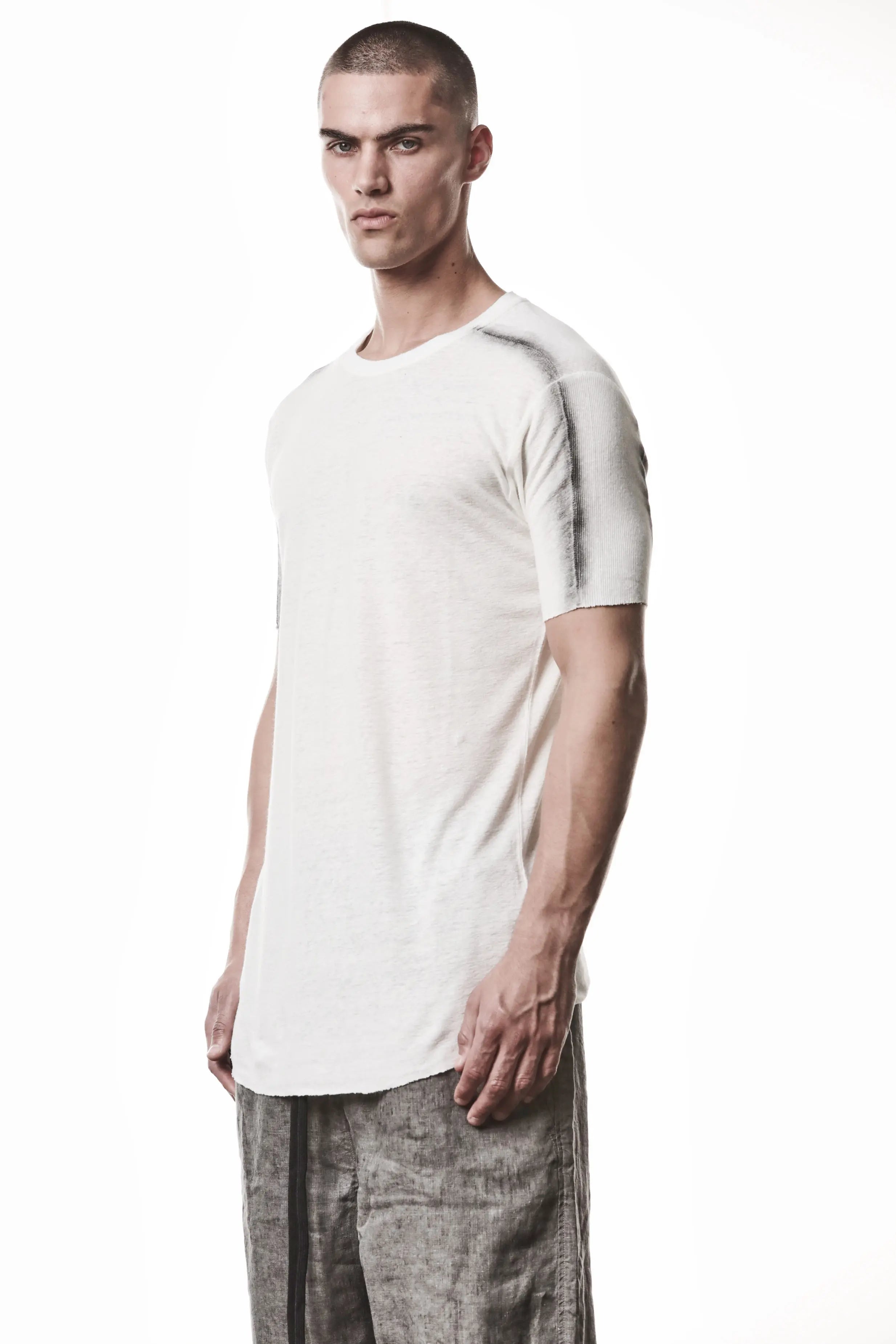 Thom Krom T-Shirt , Mens T-Shirt , Off White Cotton , Raw Cut Hem , Raw Cut Sleeves , Round Crewneck , Slim Fit , Standard Length , Signature Front Level  Shoulders Seams , Vertical Curved Dark Stiching Lines , Half Body Photo , Linen , Viscose , Cotton , Side Angle Half Body Photo