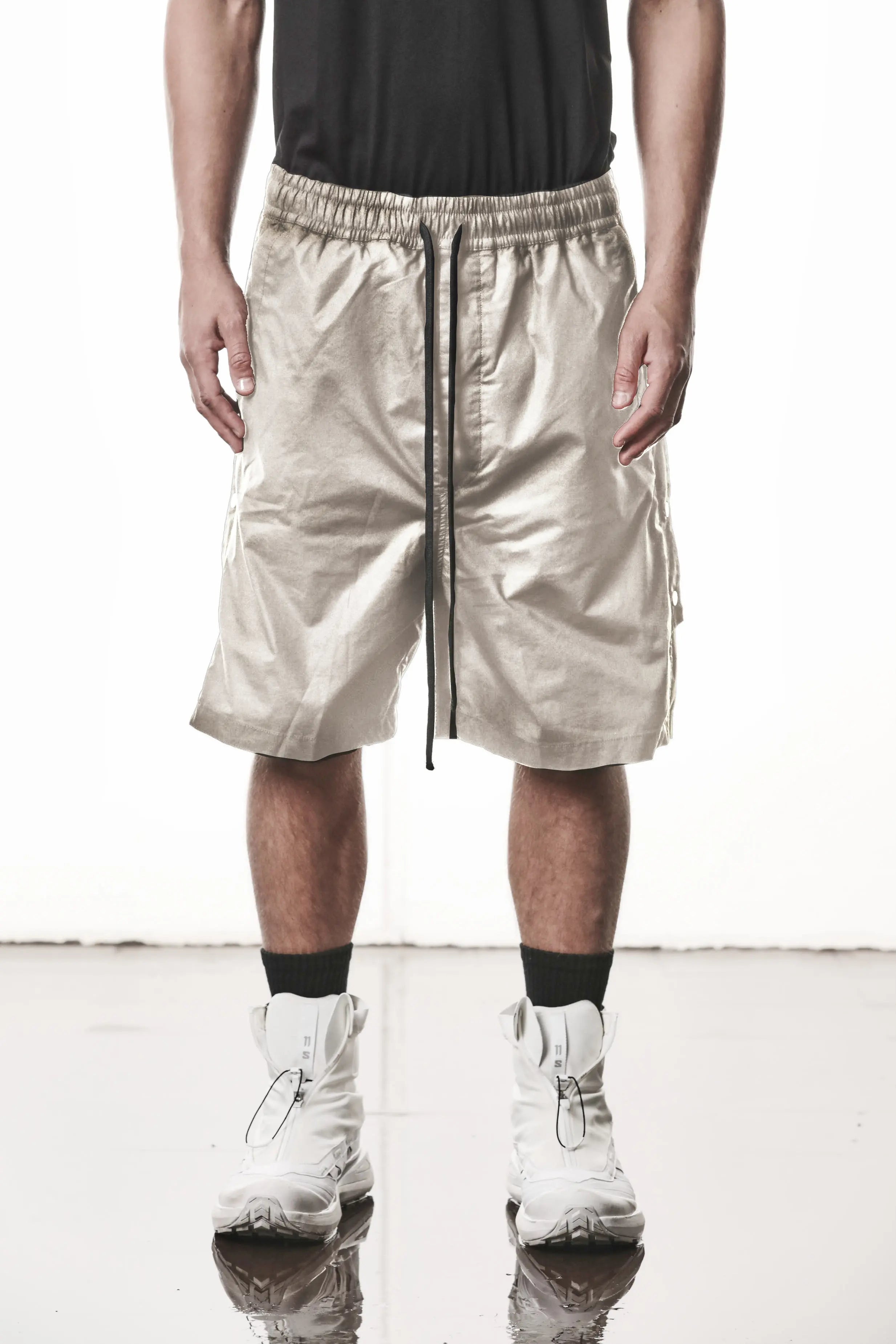 Thom Krom, Mens Shorts, Vegetal Stone, Over the Knee, Beige, Elasticated Waistband, Black Drawstring, Cargo Pockets, Side Pockets, Wide-fit, Drop-crotch, Front View. 
