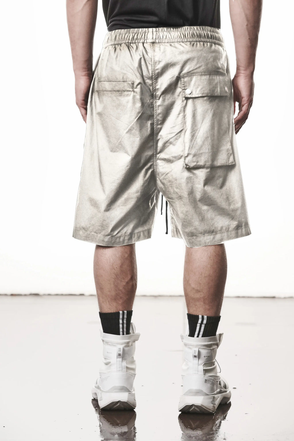Thom Krom, Mens Shorts, Vegetal Stone, Over the Knee, Beige, Elasticated Waistband, Black Drawstring, Cargo Pockets, Side Pockets, Wide-fit, Drop-crotch, Back View. 