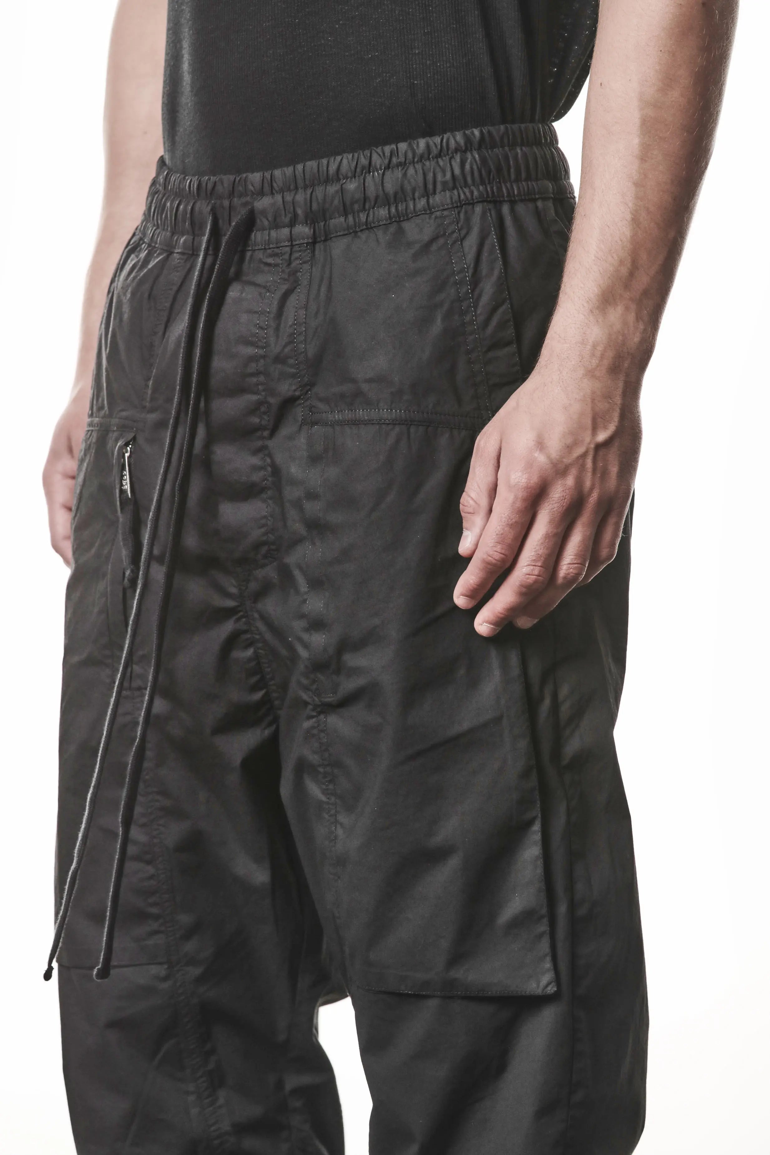 Thom Krom, Mens Pants, Black, Oversized, Wide-fit, Loose-fit, Large Front Pockets, Side Pockets, Back Pockets, Elasticated Waistband, Black Drawstring, Zip Pockets, YKK Zippers, Wide Ankles, Close-up Front 3/4 View. 