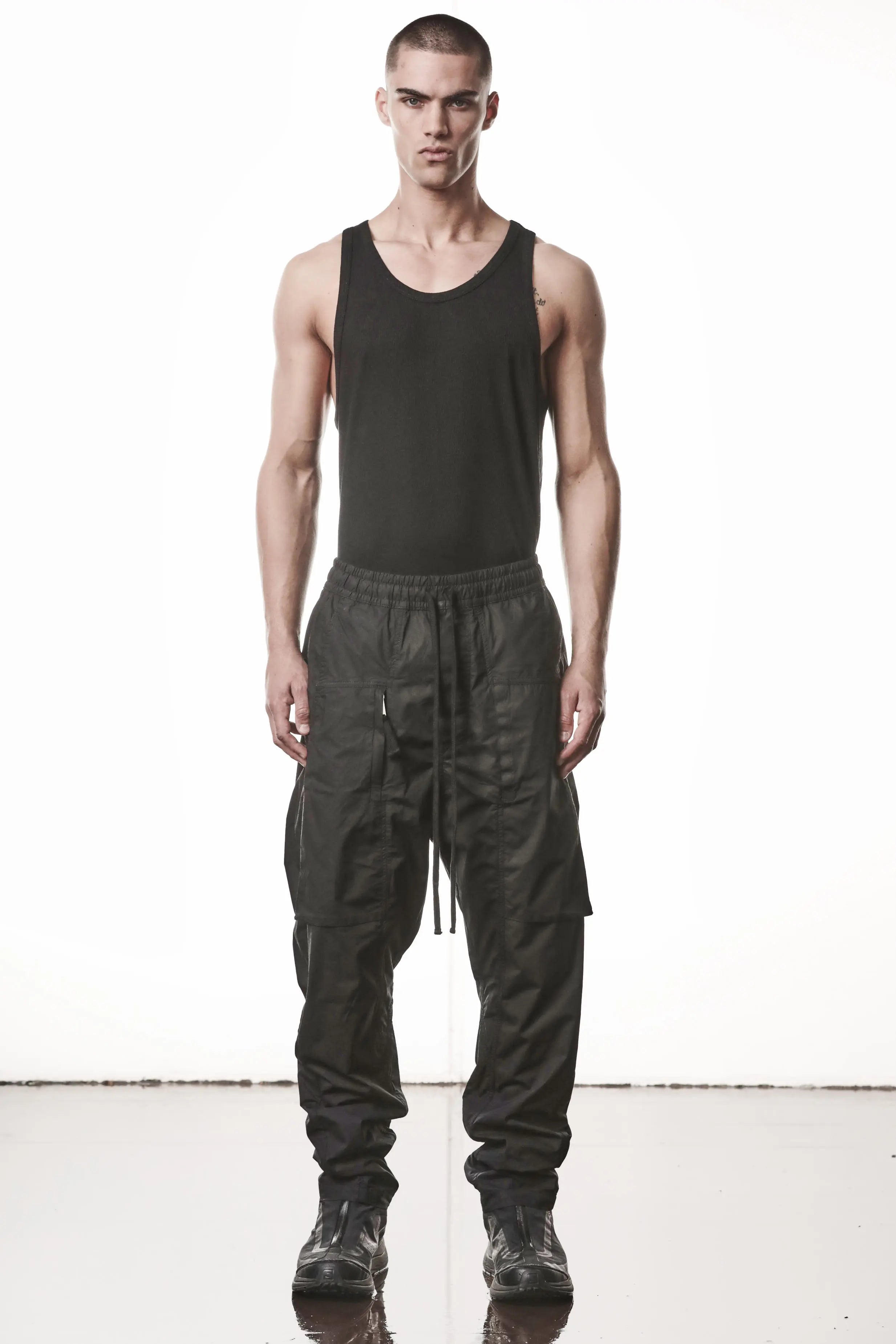Thom Krom, Mens Pants, Black, Oversized, Wide-fit, Loose-fit, Large Front Pockets, Side Pockets, Back Pockets, Elasticated Waistband, Black Drawstring, Zip Pockets, YKK Zippers, Wide Ankles, Full Body Front View. 