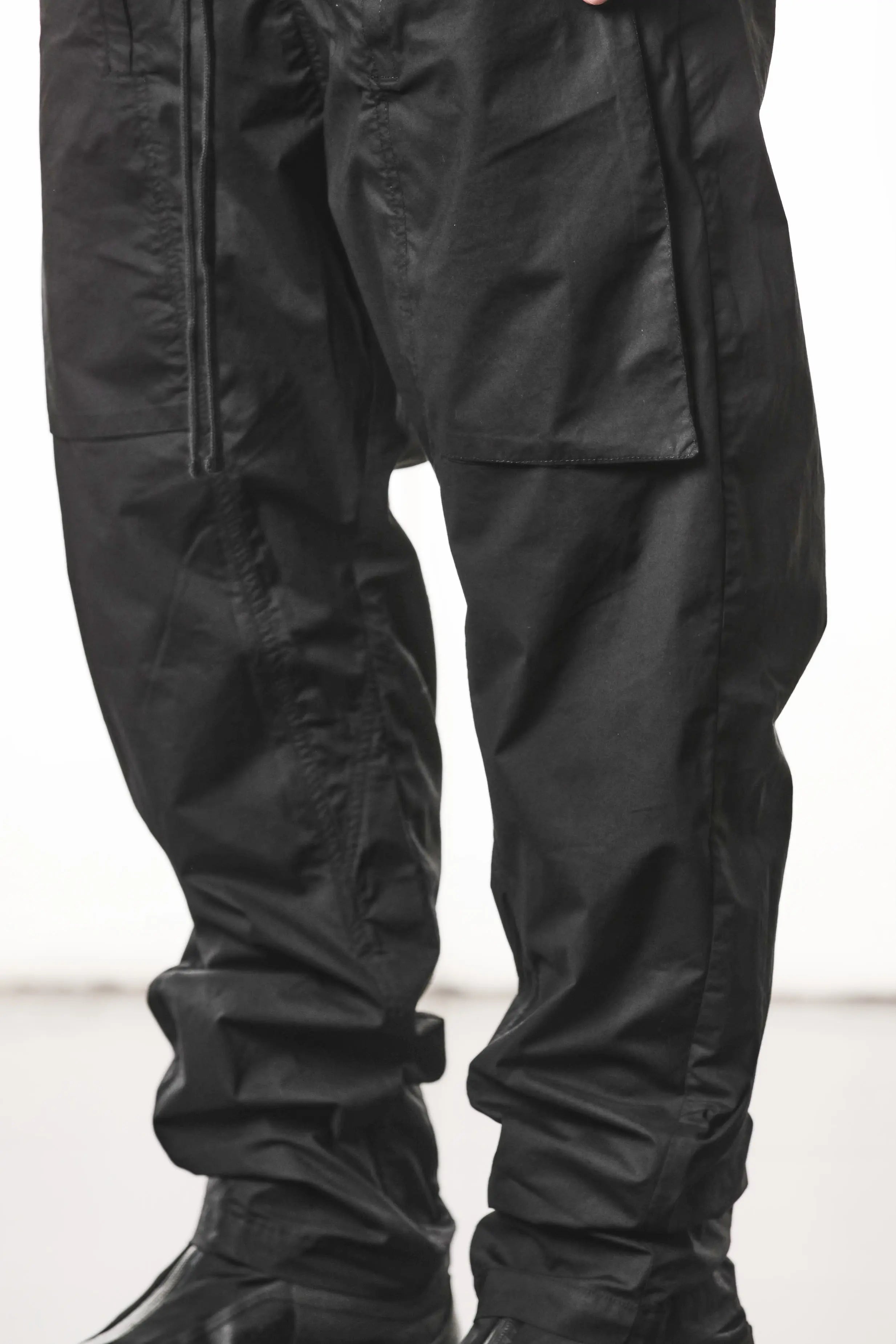 Thom Krom, Mens Pants, Black, Oversized, Wide-fit, Loose-fit, Large Front Pockets, Side Pockets, Back Pockets, Elasticated Waistband, Black Drawstring, Zip Pockets, YKK Zippers, Wide Ankles, Front 3/4 Leg Fit View. 