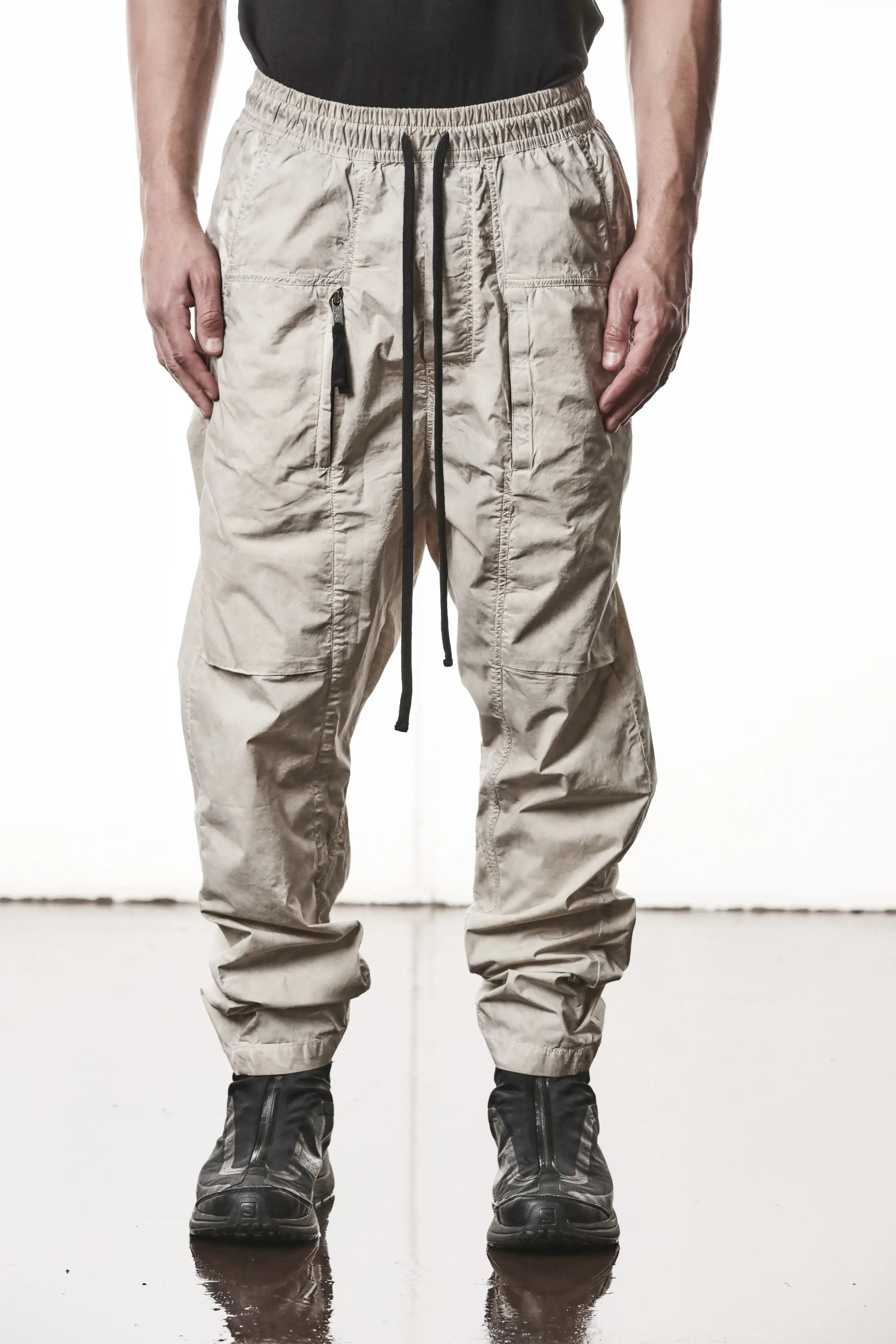 Thom Krom, Mens Pants, Vegetal Stone, Beige, Oversized, Wide-fit, Loose-fit, Large Front Pockets, Side Pockets, Back Pockets, Elasticated Waistband, Black Drawstring, Zip Pockets, YKK Zippers, Wide Ankles, Front View. 