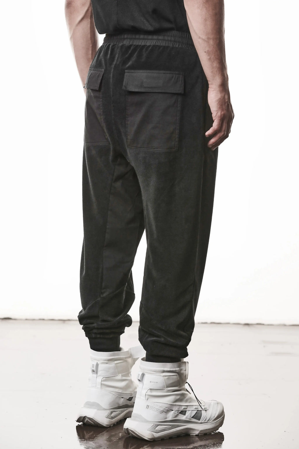 Thom Krom, Mens Pants, Black, Cotton Terry, Elasticated Waistband, Drawstring, Inserts, Side Pockets, Back Pockets, Ribbed Cuffs, The night is your friend, my love, Back Portrait 3/4 View. 