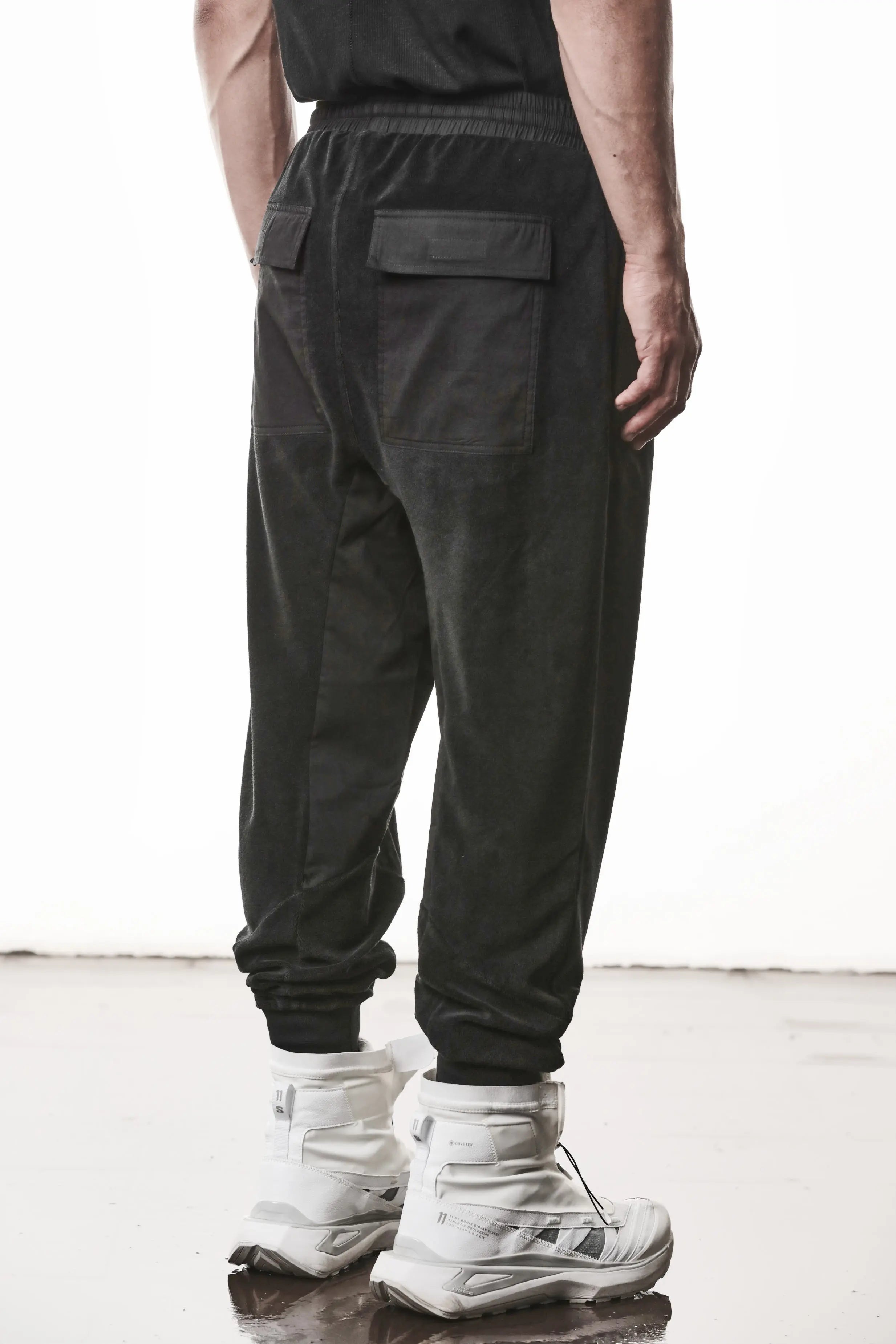 Thom Krom, Mens Pants, Black, Cotton Terry, Elasticated Waistband, Drawstring, Inserts, Side Pockets, Back Pockets, Ribbed Cuffs, The night is your friend, my love, Back Portrait 3/4 View. 