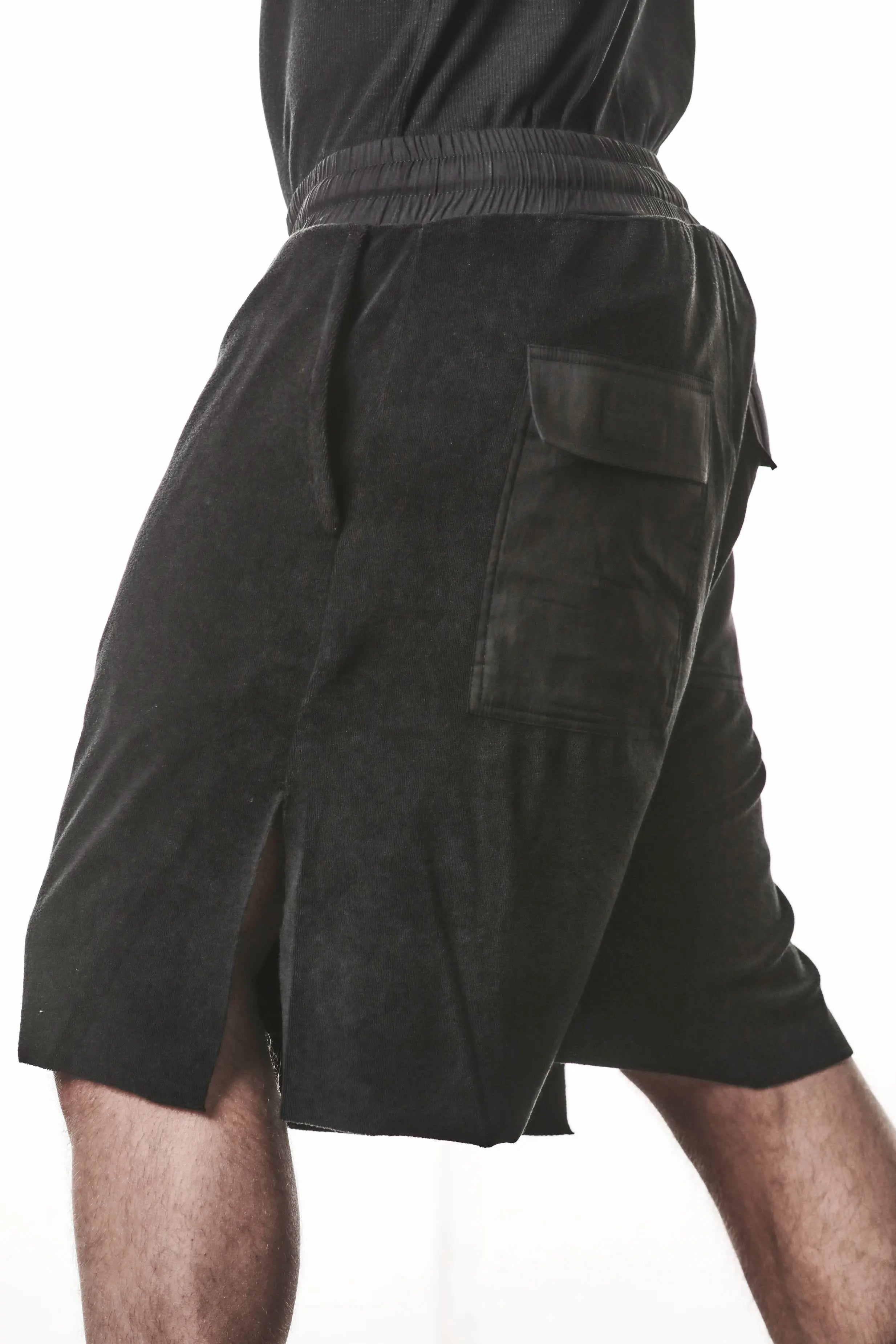 Thom Krom, Mens Shorts, Black, Elasticated Waistband, Drawstring, Raw cut hem and slits, Cotton Terry, Woven Inserts, 1/2 Legs, Side Pockets, Step Forward Side View. 