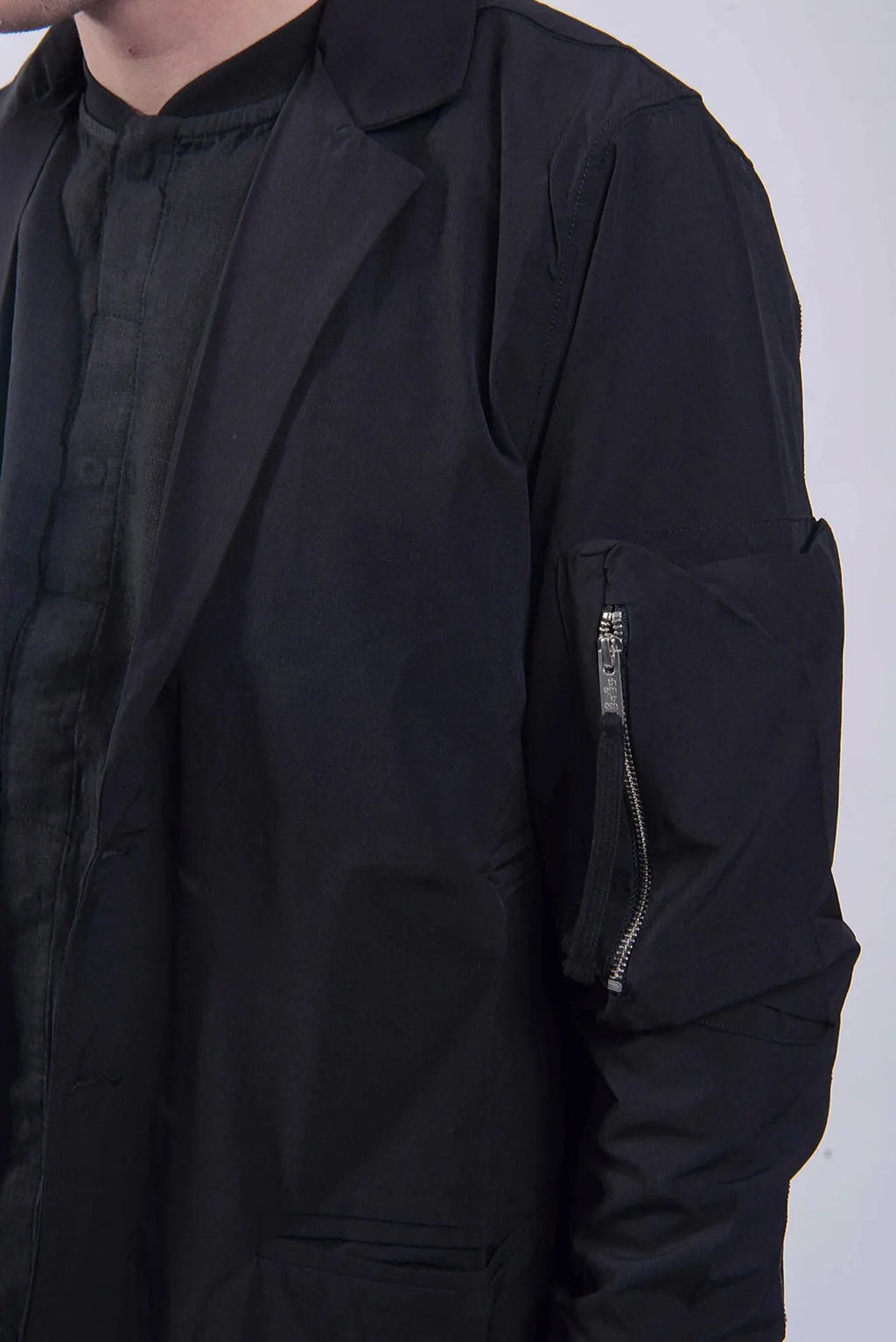 Thom Krom, Mens Coat, Black, Two-Button Closure, Sleeve Pocket, V-Neck, Bellows Pockets, Ribbed Cuffs, YKK Zipper, Close-up Zip Pocket Showcase. 