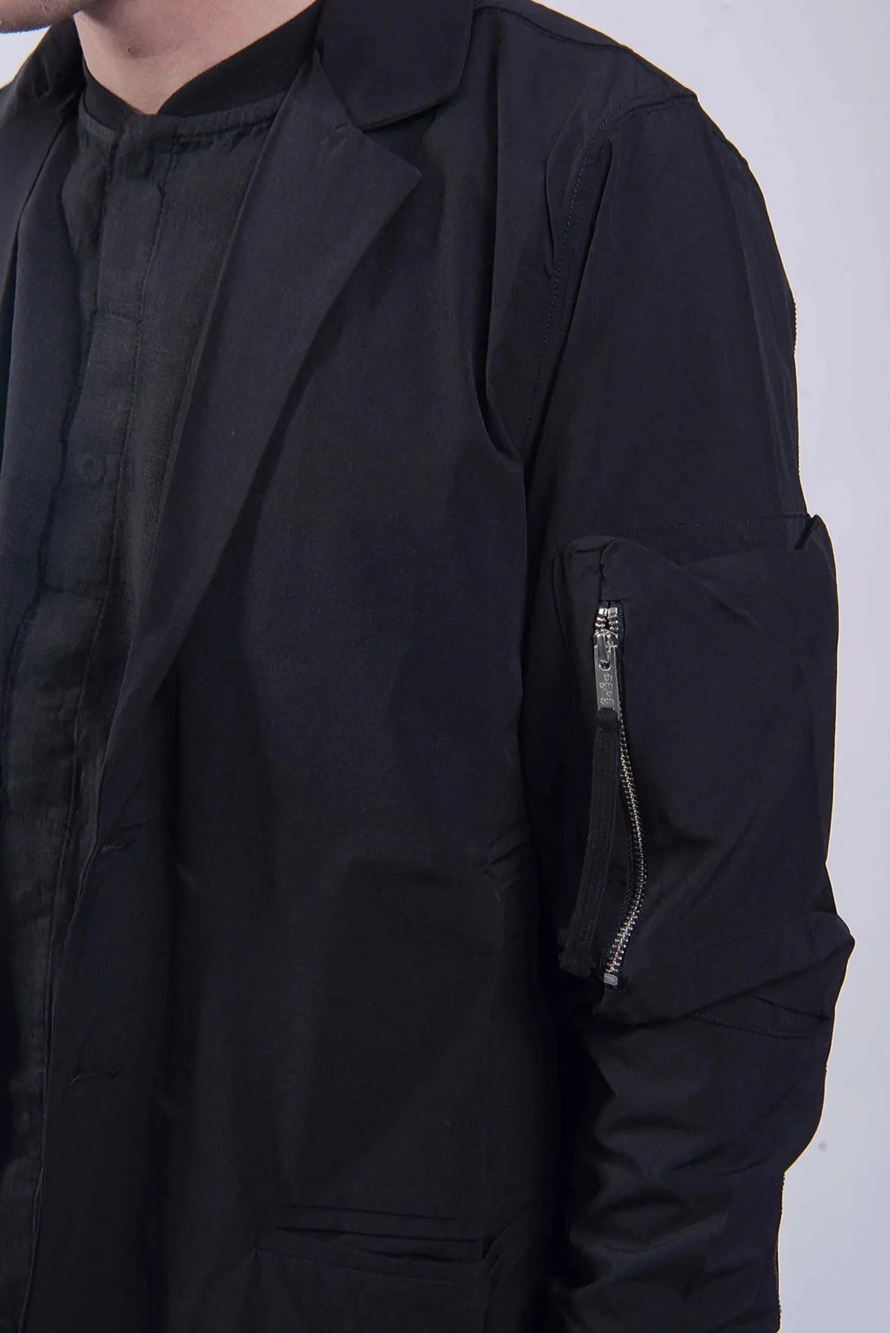 Thom Krom, Mens Coat, Black, Two-Button Closure, Sleeve Pocket, V-Neck, Bellows Pockets, Ribbed Cuffs, YKK Zipper, Close-up Zip Pocket Showcase. 