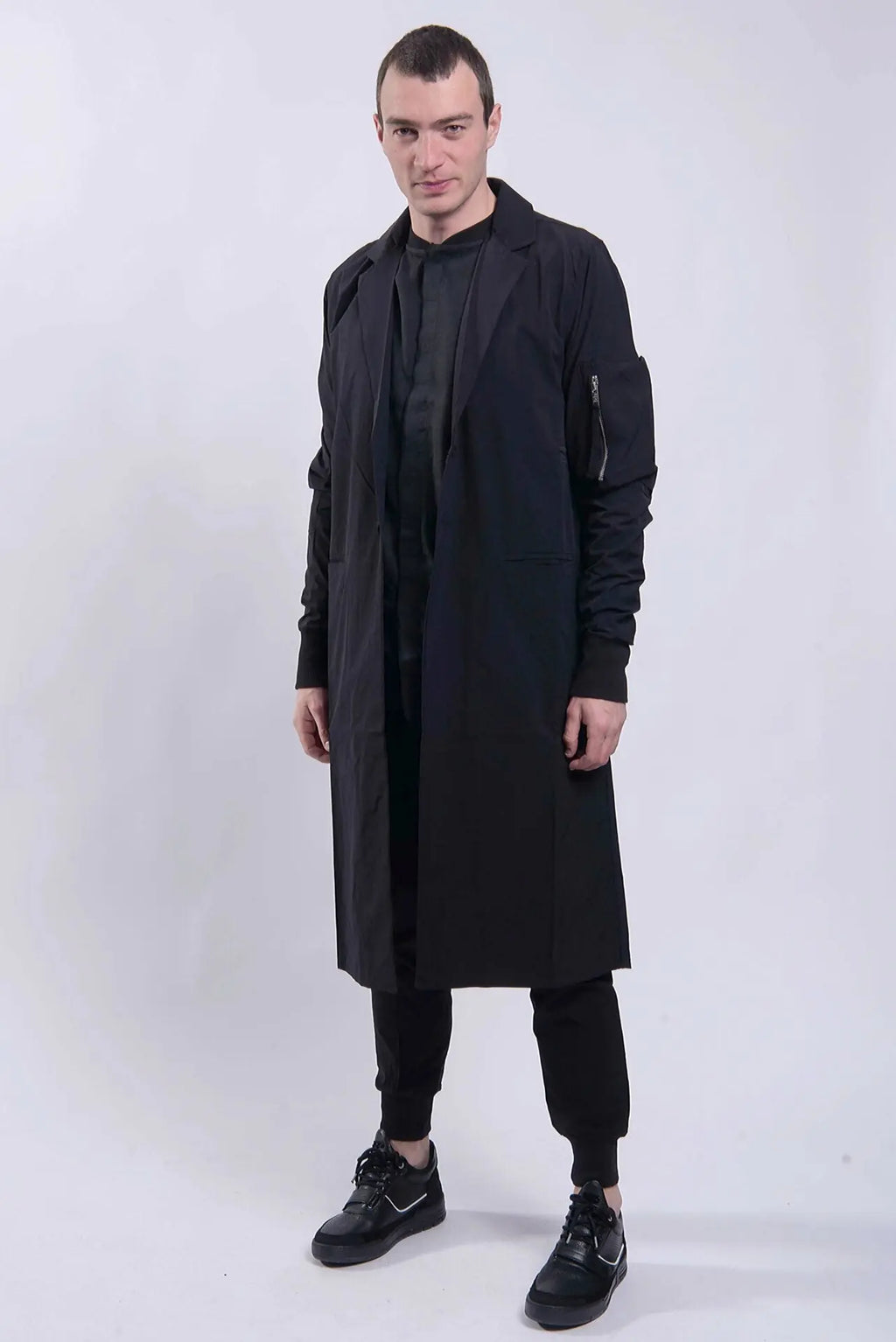 Thom Krom, Mens Coat, Black, Two-Button Closure, Sleeve Pocket, V-Neck, Bellows Pockets, Ribbed Cuffs, YKK Zipper, Full Body In-motion Front View. 