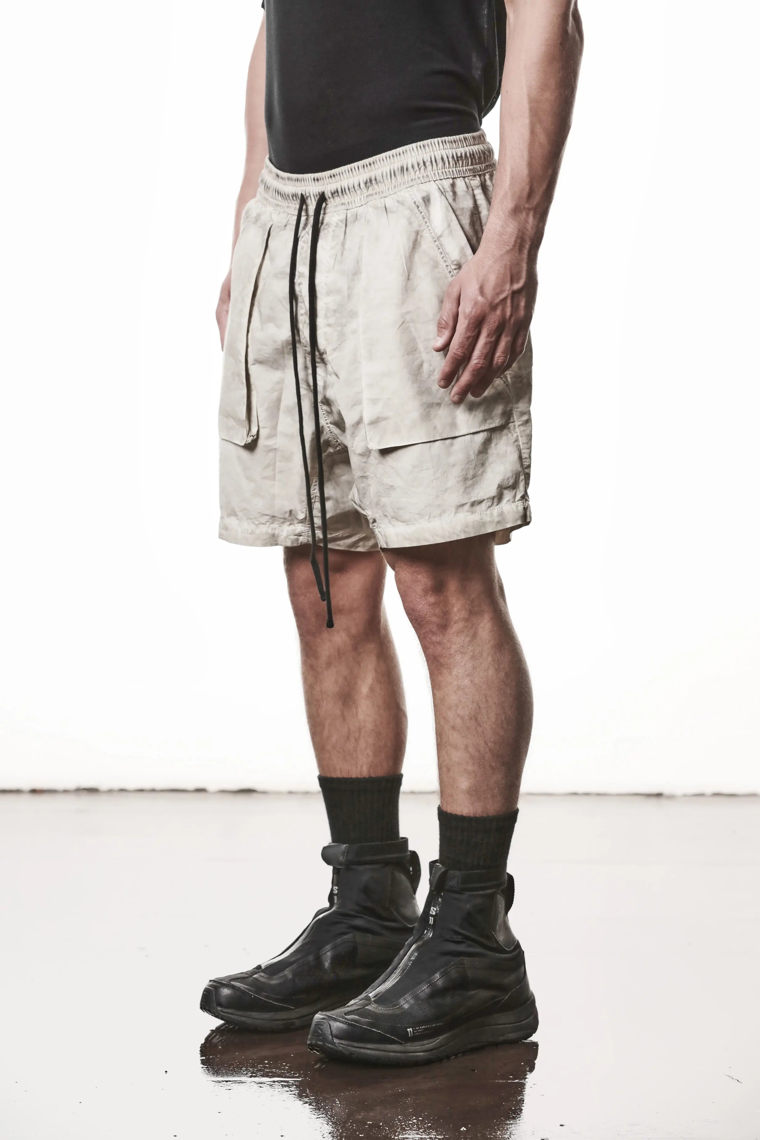 Thom Krom, Mens Shorts, Vegetal Stone, Beige, Elasticated Waistband, Drawsting, Funtional Front and Side Pockets, YKK Zipper, Zip Fly, Wide-fit, Above the Knee, Front 3/4 View. 