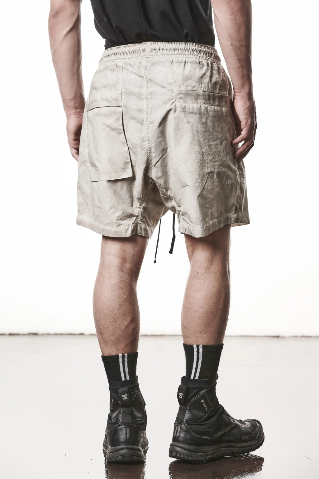 Thom Krom, Mens Shorts, Vegetal Stone, Beige, Elasticated Waistband, Drawsting, Funtional Front and Side Pockets, YKK Zipper, Zip Fly, Wide-fit, Above the Knee, Back View. 