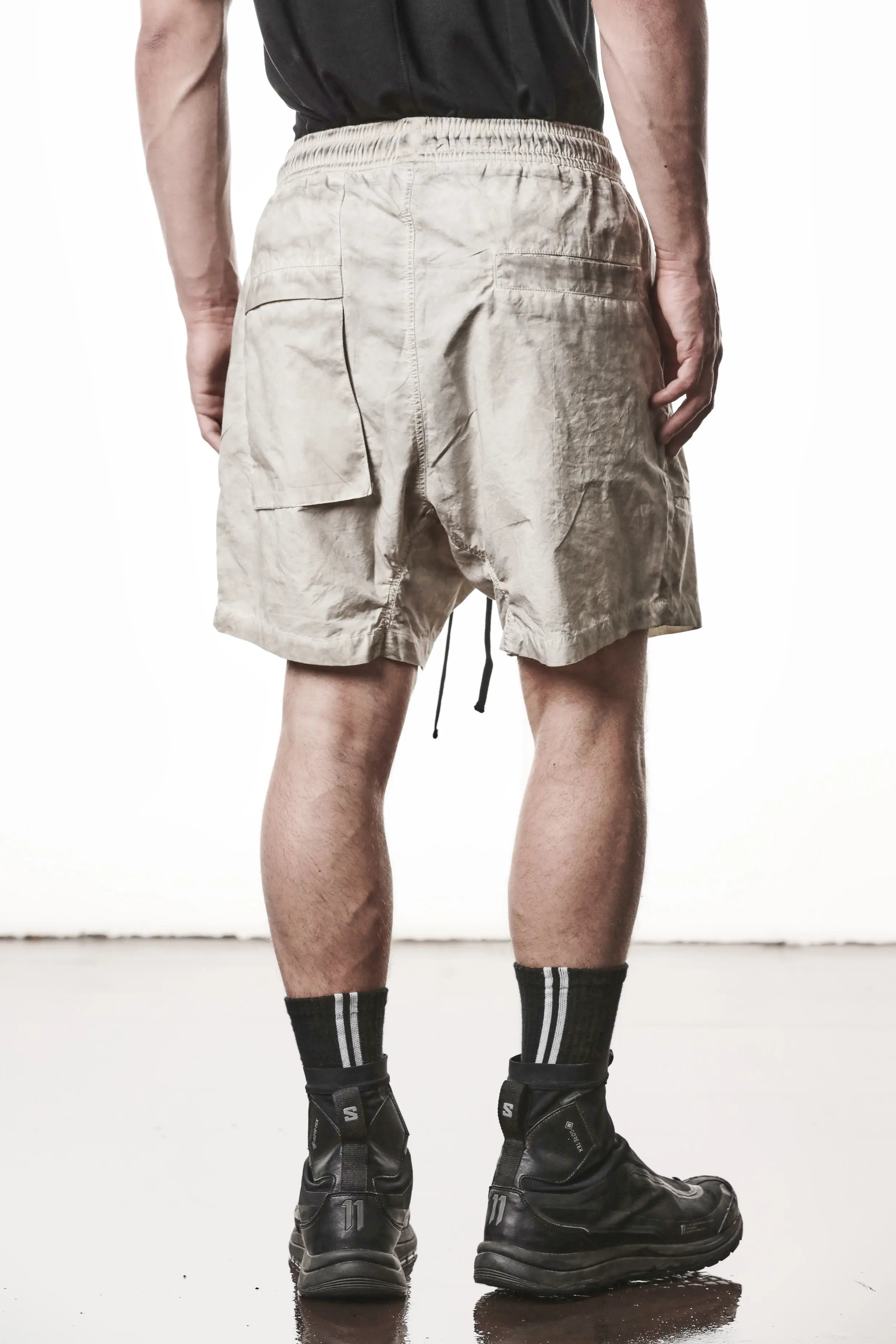Thom Krom, Mens Shorts, Vegetal Stone, Beige, Elasticated Waistband, Drawsting, Funtional Front and Side Pockets, YKK Zipper, Zip Fly, Wide-fit, Above the Knee, Back View. 