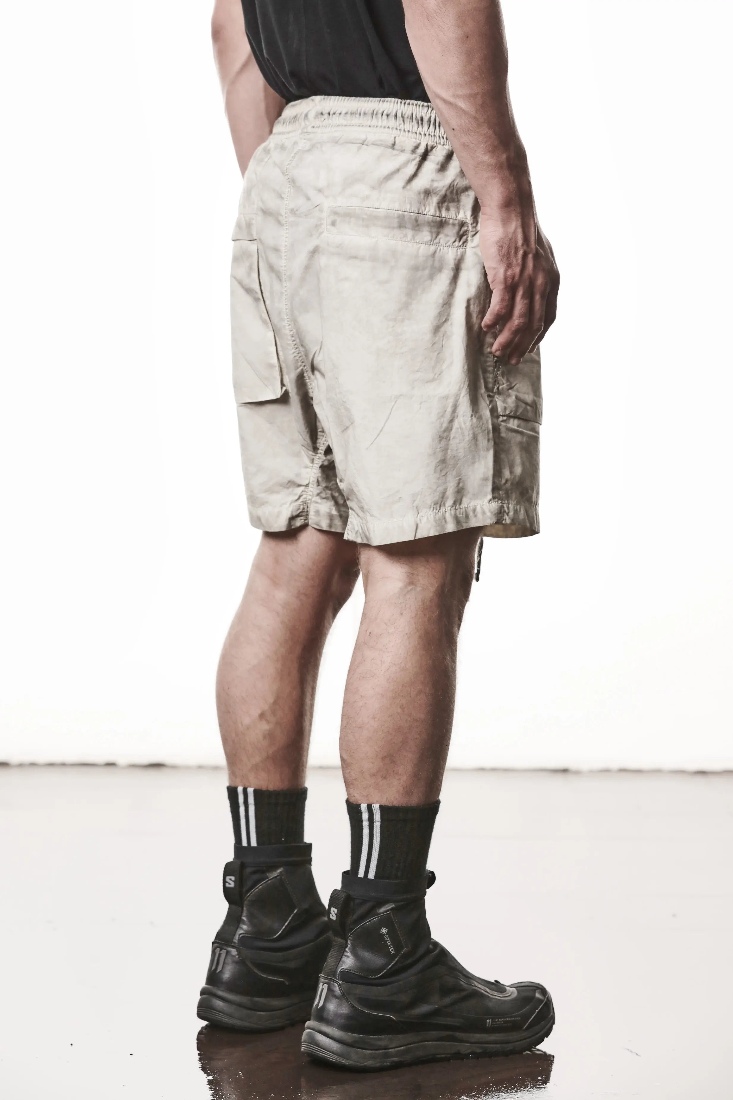 Thom Krom, Mens Shorts, Vegetal Stone, Beige, Elasticated Waistband, Drawsting, Funtional Front and Side Pockets, YKK Zipper, Zip Fly, Wide-fit, Above the Knee, Back 3/4 View. 