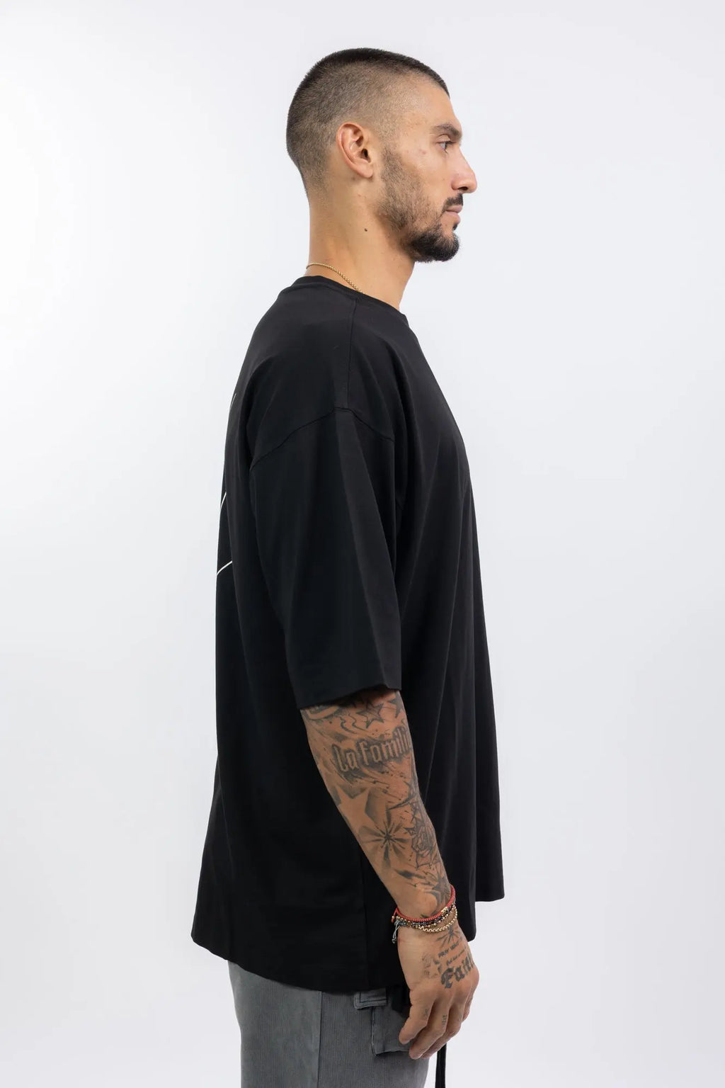 Thom Krom,Mens T-Shirt,Black,Oversized Fit,Round Crewneck,Embroidered Logo On The Back,Print At Backside,Straight Hemline,Folded Hems,Soft Strong Modal Jersey,Profile View.