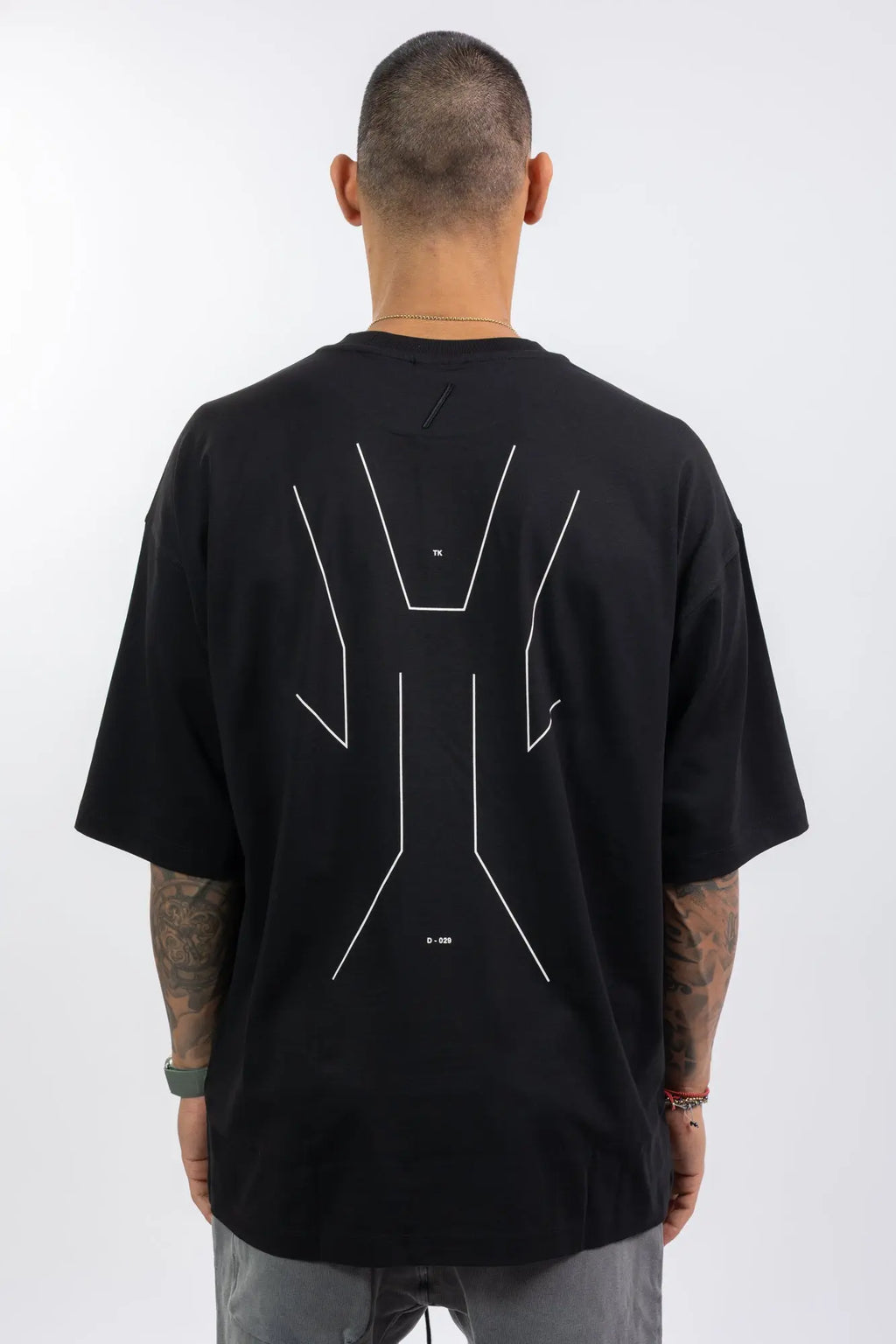 Thom Krom,Mens T-Shirt,Black,Oversized Fit,Round Crewneck,Embroidered Logo On The Back,Print At Backside,Straight Hemline,Folded Hems,Soft Strong Modal Jersey,Back View.