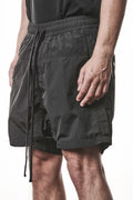 Thom Krom, Mens Shorts, Black, Polyamide, Side Pockets, Elasticated Waistband, Drawsting, Cross Seams, Wide Fit, Over the Knee Legs, Drop-Crotch, Hidden Zip Pockets, Front 3/4 View. 