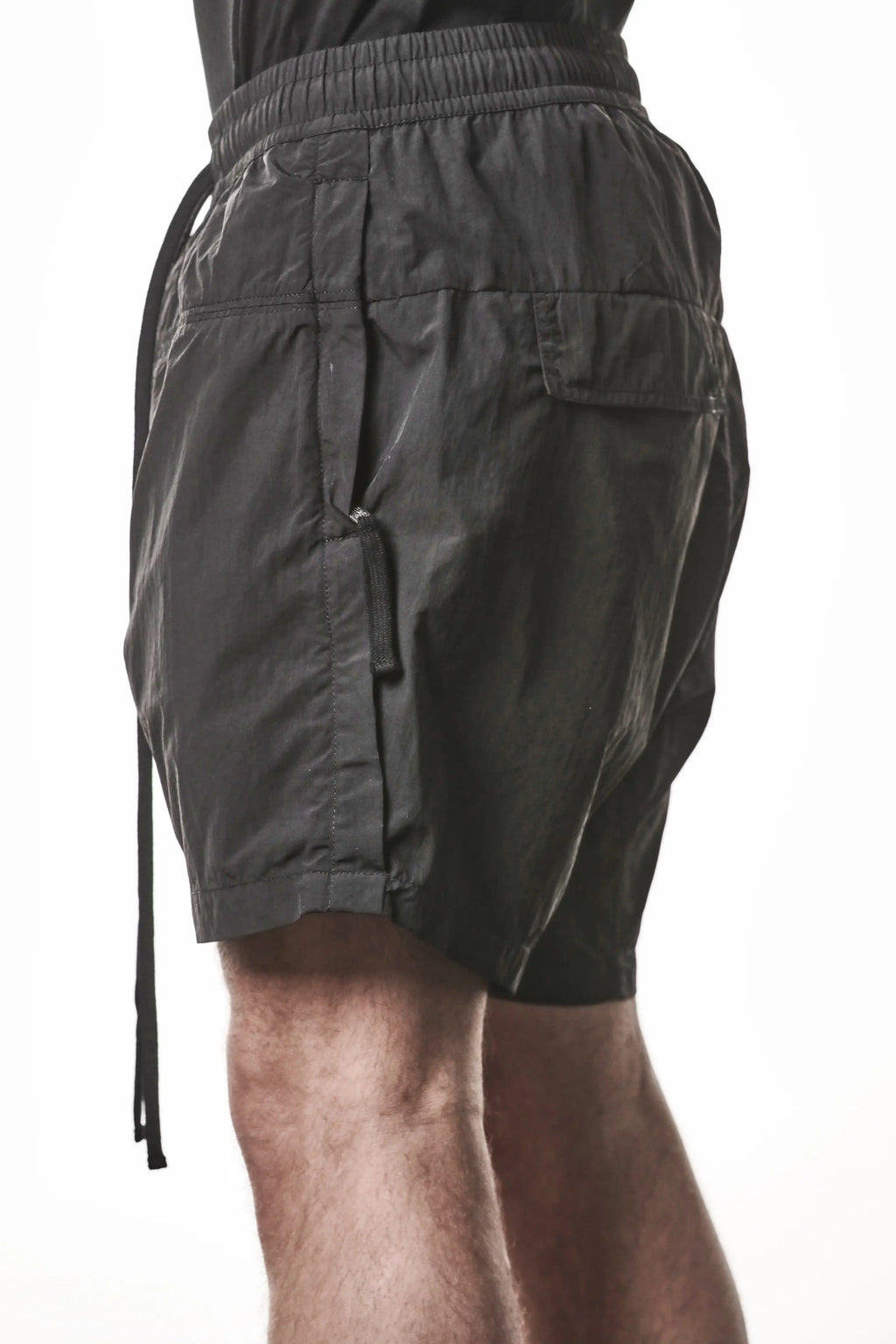 Thom Krom, Mens Shorts, Black, Polyamide, Side Pockets, Elasticated Waistband, Drawsting, Cross Seams, Wide Fit, Over the Knee Legs, Drop-Crotch, Hidden Zip Pockets, Side View. 