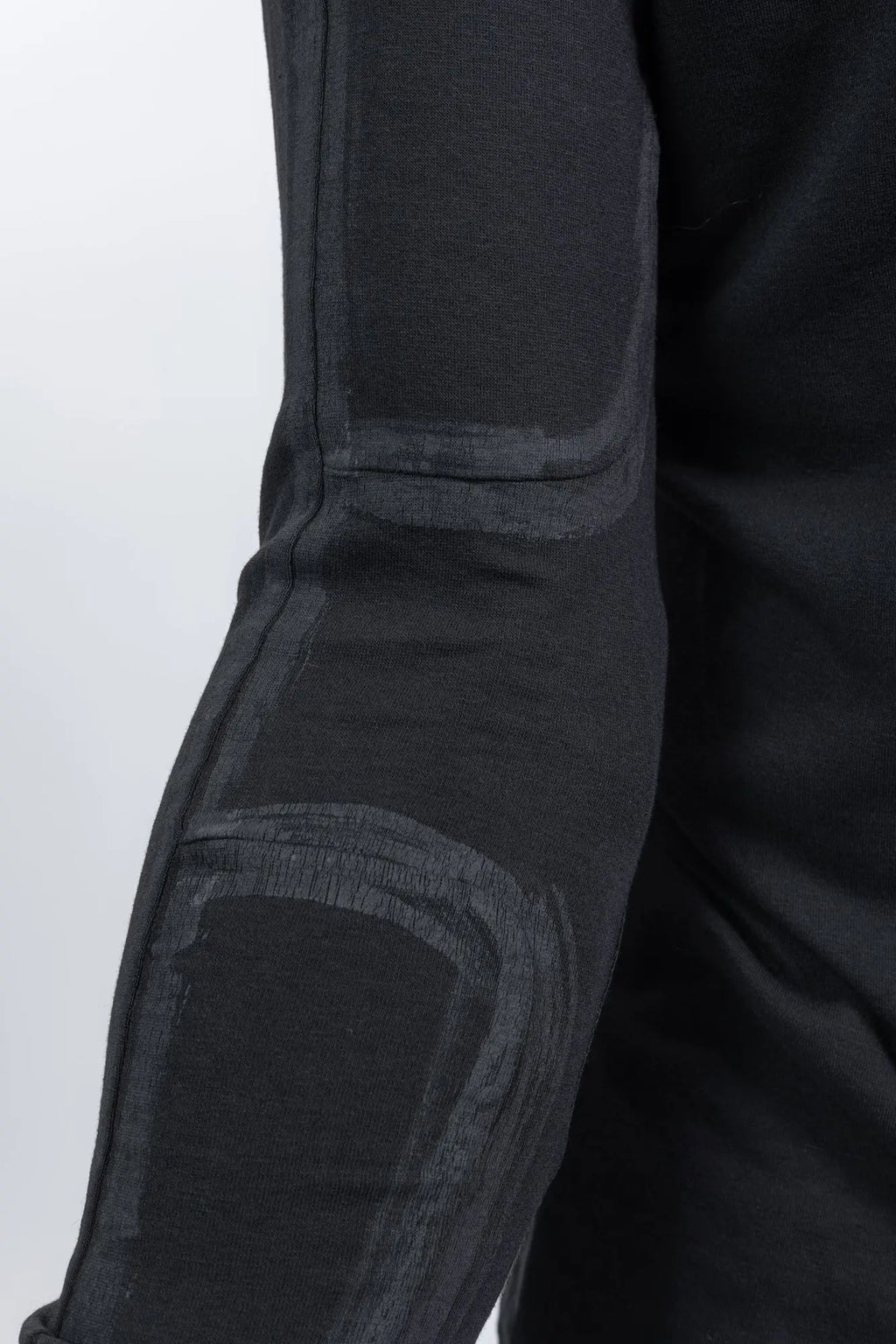 Thom Krom,Mens Longsleeve,Black,Handpainted,Regular Fit,Ribbed Round Crewneck,Long Ranglan Sleeves,Tonal Handpainted Details On Shoulders Back And Sleeves,Straight Hem,Distinctive Long Center Seam Running Down The Back, Close Up Photo Of The Handpainted Details.