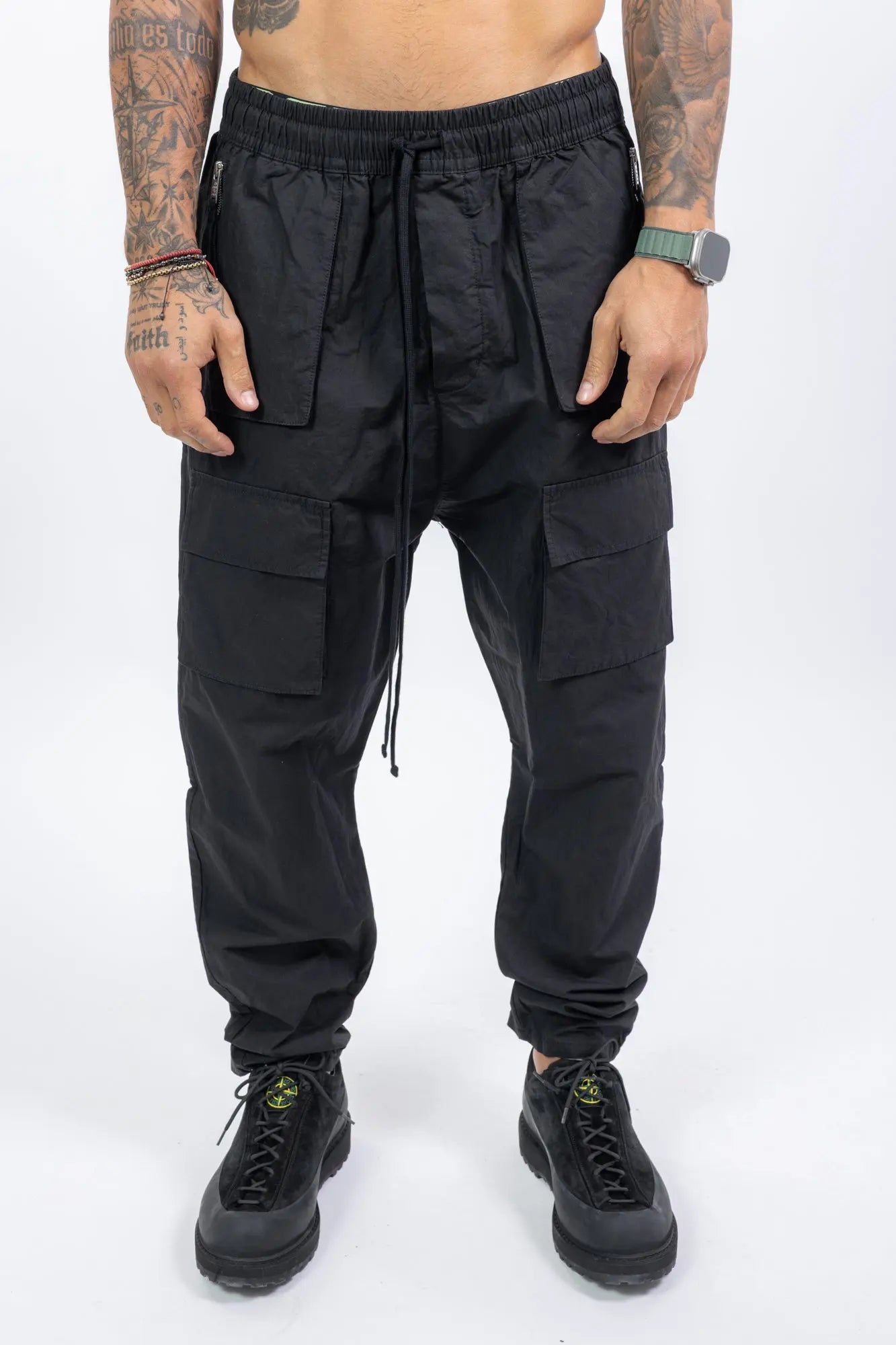 Thom Krom,Mens Trousers,Relaxed Fit,Mid-Rise Waist,Drop Crotch,Tapered Leg,Elastic Waistband With Adjustable Drawstring,Concealed Button Placket With Logo Buttons At The Front,Two Patch Bellows Pockets With Zipper On The Front,Two Patch Bellow pockets With Flaps On The Front,Welt Pocket 
And Patch Bellows Pocket With Flap On The Back,Security Pocket With Zipper On The Inside,Leg Hem With Elastic Insert On The Back, Front Portrait.