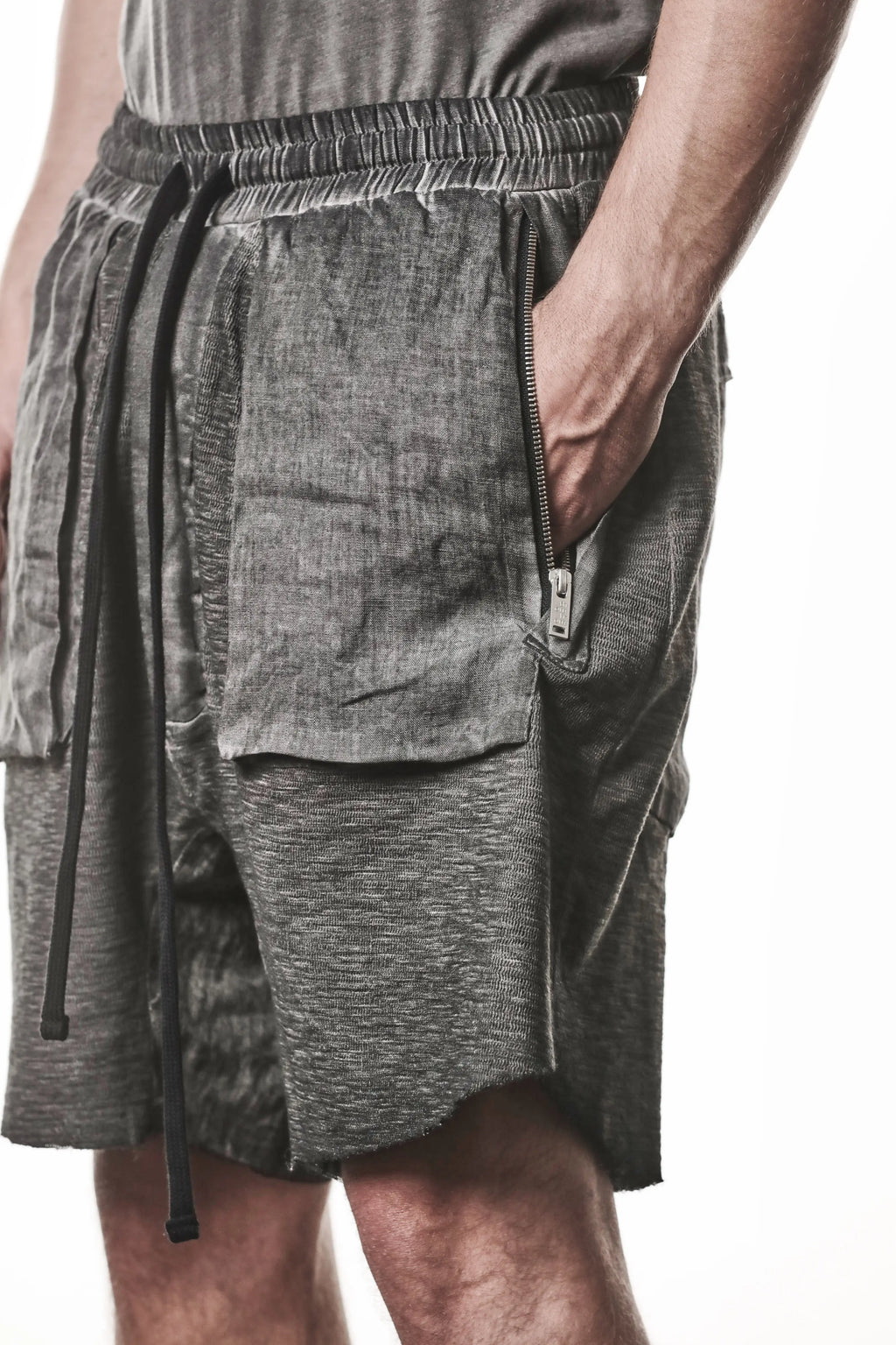 Thom Krom Shorts,Mens Shorts,Drop Crotch,Elasticated Waistband With Drawstrings,Regular Straight Fit,Raw Cut Hem Detailing,Lenght Above The Knee,Woven Linen Insert in Crotch,Bellow And Welt Pocket Construction,Hidden Zip Pockets At Front,Close Up Photo Side Angle