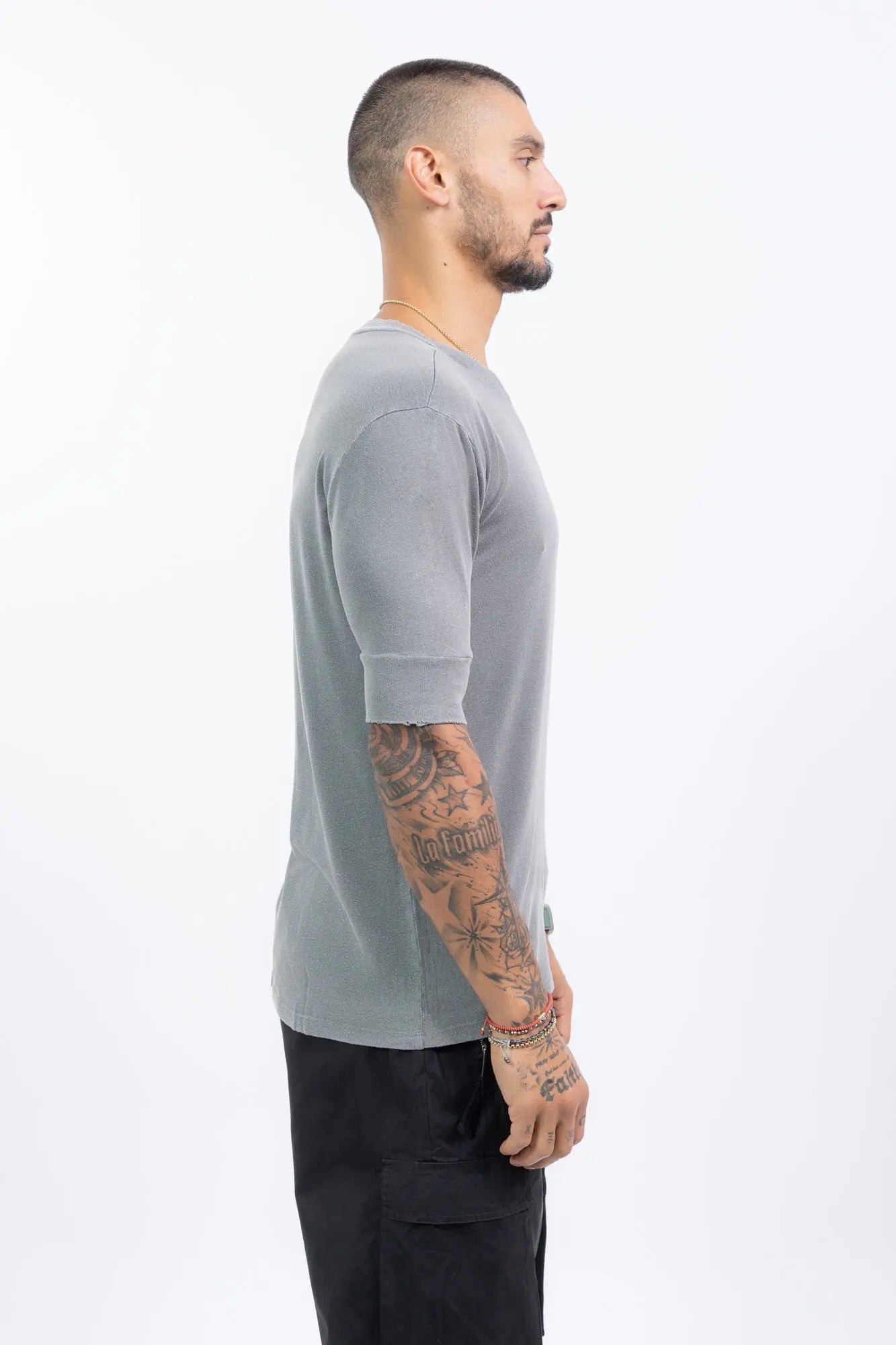 Thom Krom,Mens T-Shirt,Used Grey,Raw Cut Hems,Round  Distressed Crewneck,Straight Hemline,Back Center Seam Detail,Embroidered Logo On The Back,Long Sleeve Cut Detail,Profile Photo.