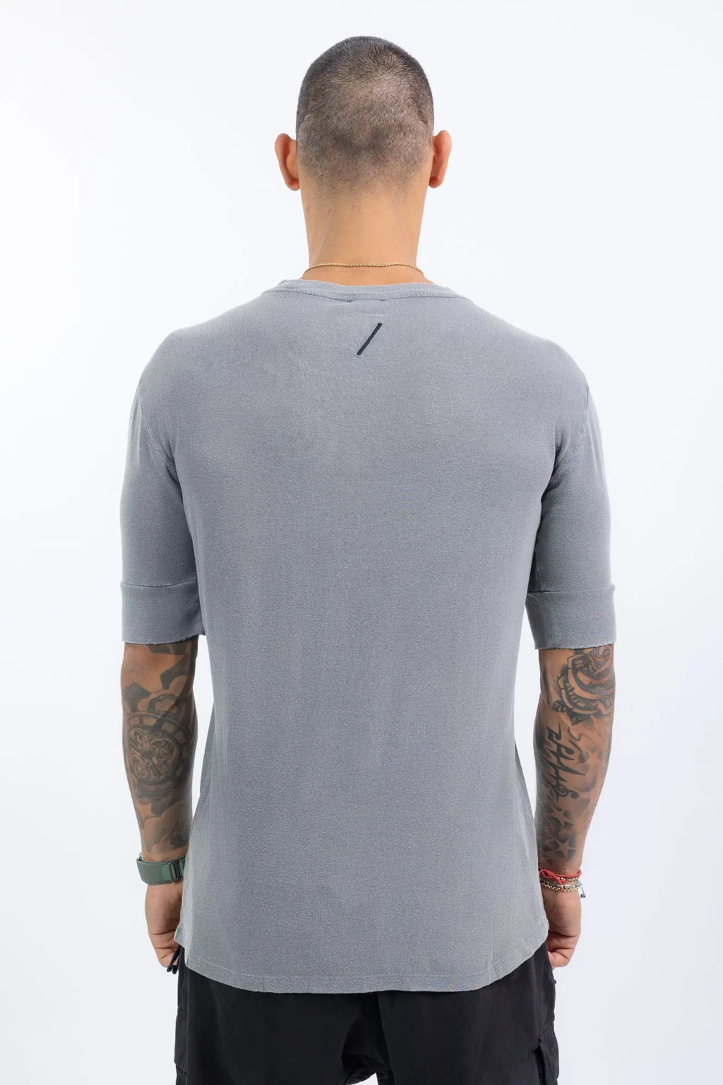 Thom Krom,Mens T-Shirt,Used Grey,Raw Cut Hems,Round  Distressed Crewneck,Straight Hemline,Back Center Seam Detail,Embroidered Logo On The Back,Long Sleeve Cut Detail,Back View.