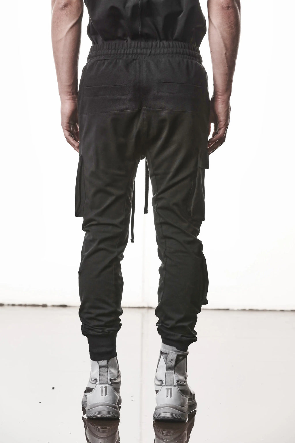 Thom Krom, Mens Pants, Black, Cargo Pockets, Stretch Cotton, Elastane, Spandex, Elasticated Waistband, Drawstring, Elasticated Cuffs, Long Legs, Regular Fit, Side Pockets, YKK Zippers, Back View. 