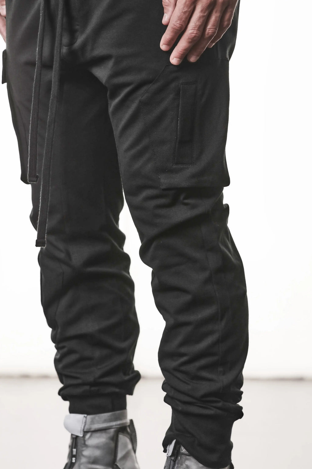 Thom Krom, Mens Pants, Black, Cargo Pockets, Stretch Cotton, Elastane, Spandex, Elasticated Waistband, Drawstring, Elasticated Cuffs, Long Legs, Regular Fit, Side Pockets, YKK Zippers, Close-up Front 3/4 View. 