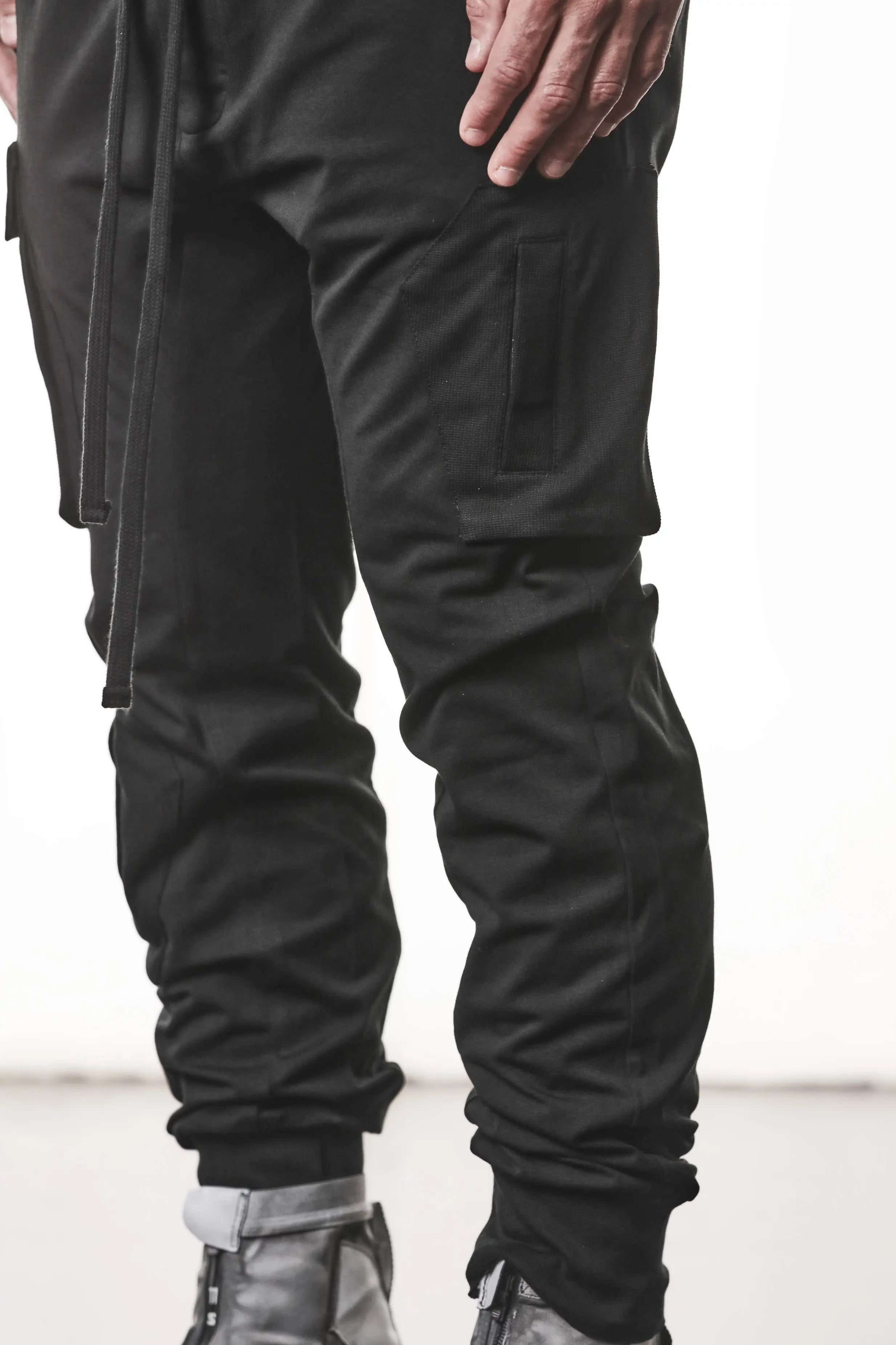 Thom Krom, Mens Pants, Black, Cargo Pockets, Stretch Cotton, Elastane, Spandex, Elasticated Waistband, Drawstring, Elasticated Cuffs, Long Legs, Regular Fit, Side Pockets, YKK Zippers, Close-up Front 3/4 View. 