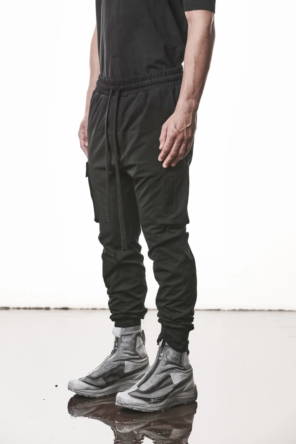 Thom Krom, Mens Pants, Black, Cargo Pockets, Stretch Cotton, Elastane, Spandex, Elasticated Waistband, Drawstring, Elasticated Cuffs, Long Legs, Regular Fit, Side Pockets, YKK Zippers, Front 3/4 View. 