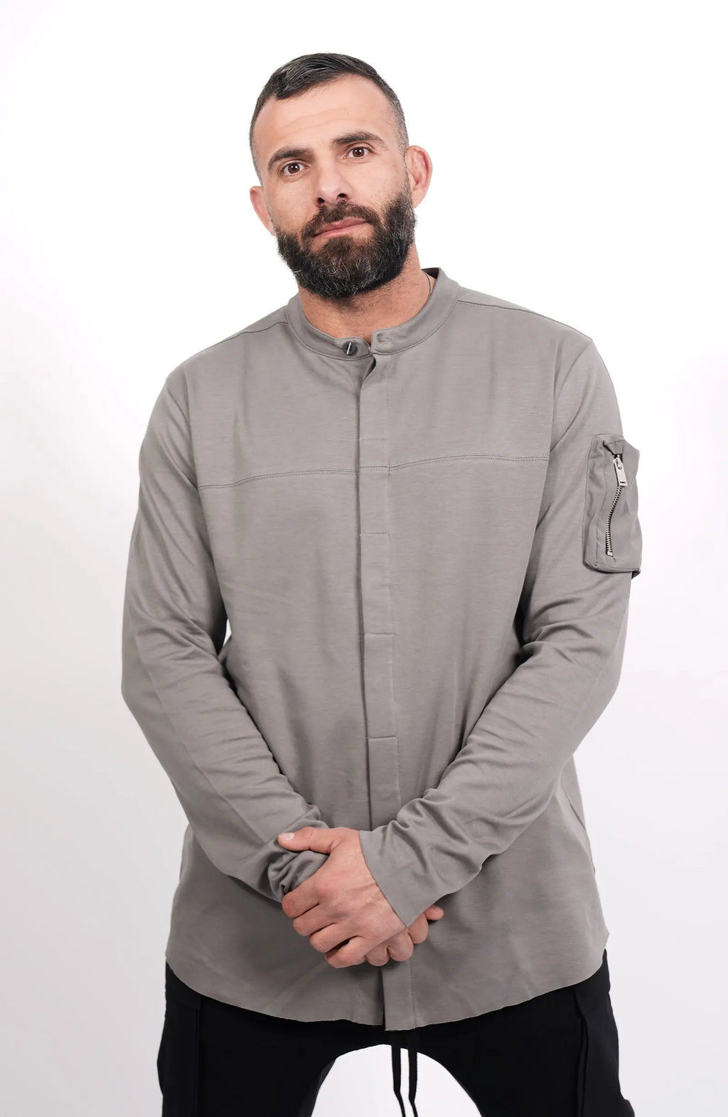 Thom Krom, Mens Shirt, Anthracite Grey, Long Sleeves, Hidden Placket, Sleeve Zip Pocket, Stand up Collar, Exposed Seams, Front Portrait Holding Hands. 