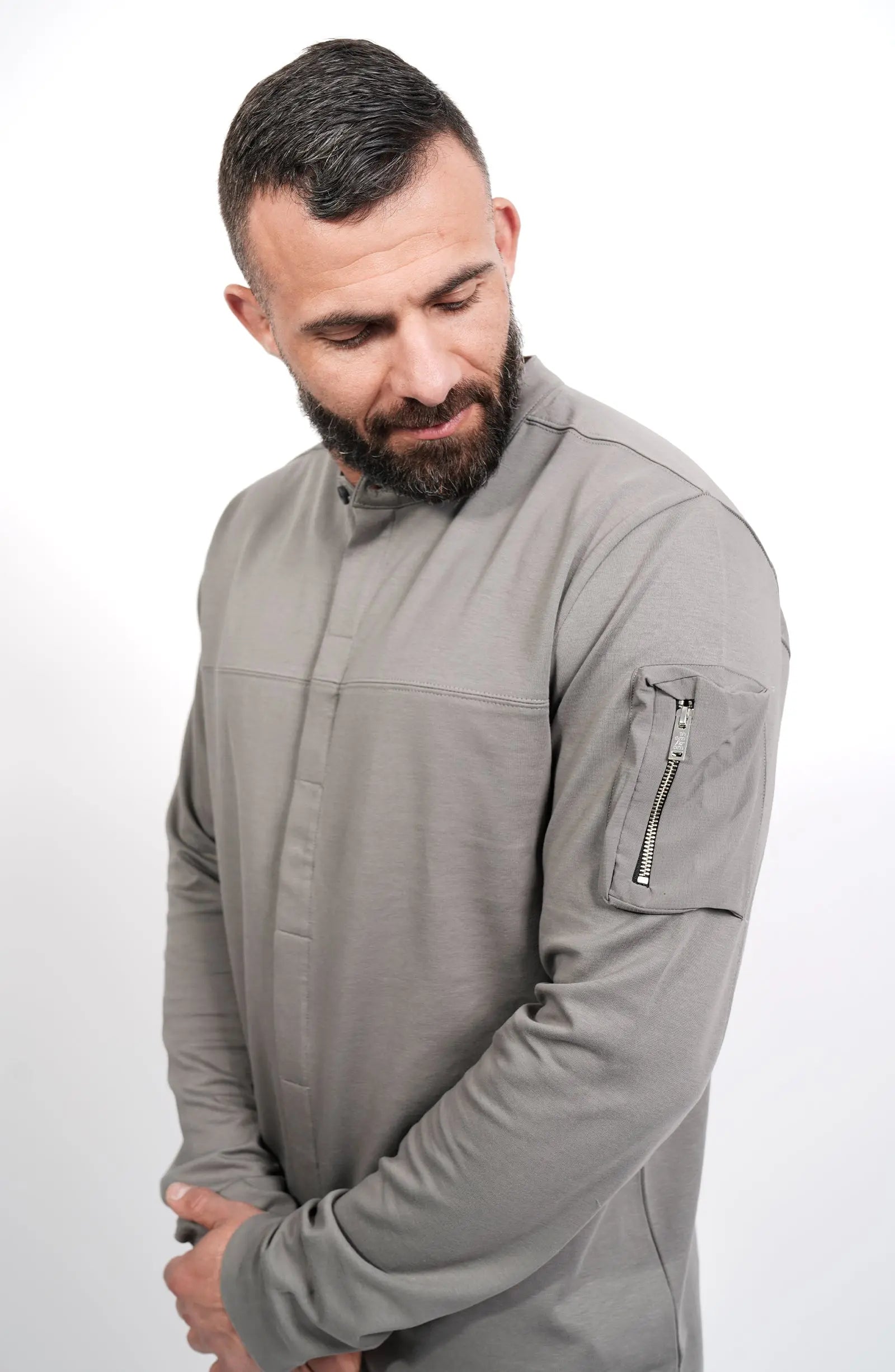 Thom Krom, Mens Shirt, Anthracite Grey, Long Sleeves, Hidden Placket, Sleeve Zip Pocket, Stand up Collar, Exposed Seams, Close-up Front 3/4 Portrait View. 