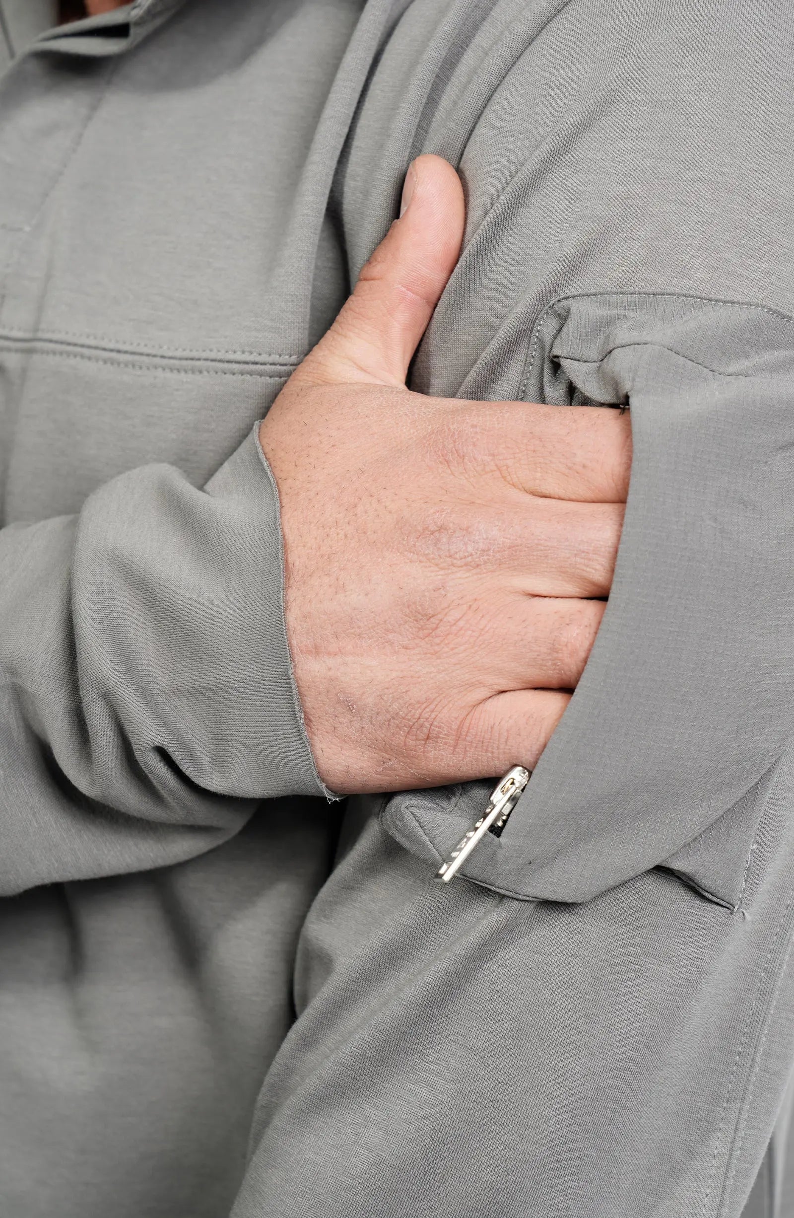 Thom Krom, Mens Shirt, Anthracite Grey, Long Sleeves, Hidden Placket, Sleeve Zip Pocket, Stand up Collar, Exposed Seams, Close-up Front View Hand in Pocket. 