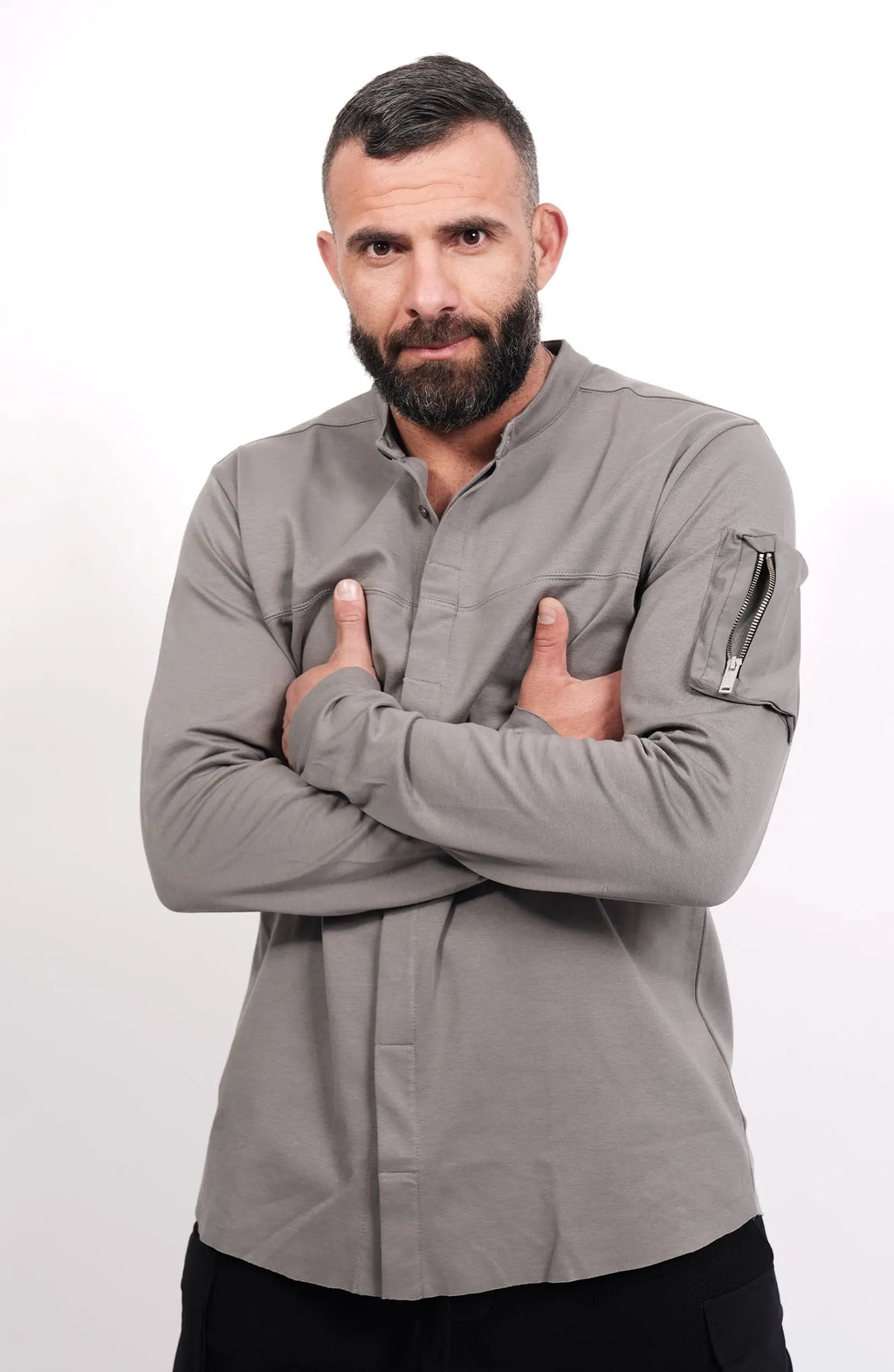 Thom Krom, Mens Shirt, Anthracite Grey, Long Sleeves, Hidden Placket, Sleeve Zip Pocket, Stand up Collar, Exposed Seams, Crossed Arms Portrait. 