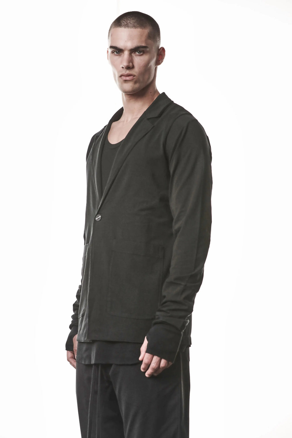 Thom Krom, Mens Blazer, Black, Shoulder Rib Patch, Thumbholes, 100% Cotton, Spandex, One Button, Thom Krom Button, Bellows Pockets, Long Sleeves, Regular Fit, Front Portrait 3/4 View. 