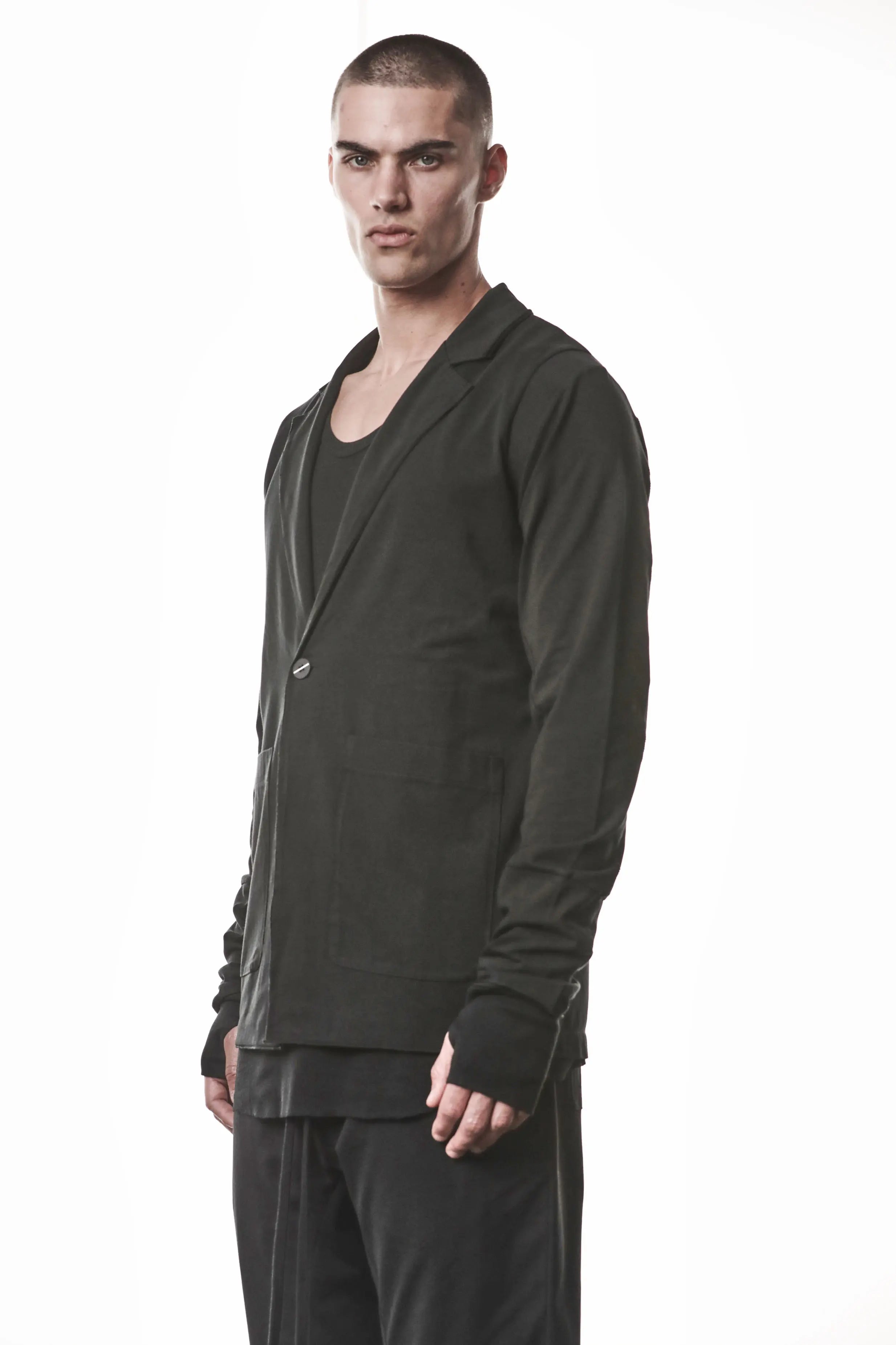 Thom Krom, Mens Blazer, Black, Shoulder Rib Patch, Thumbholes, 100% Cotton, Spandex, One Button, Thom Krom Button, Bellows Pockets, Long Sleeves, Regular Fit, Front Portrait 3/4 View. 
