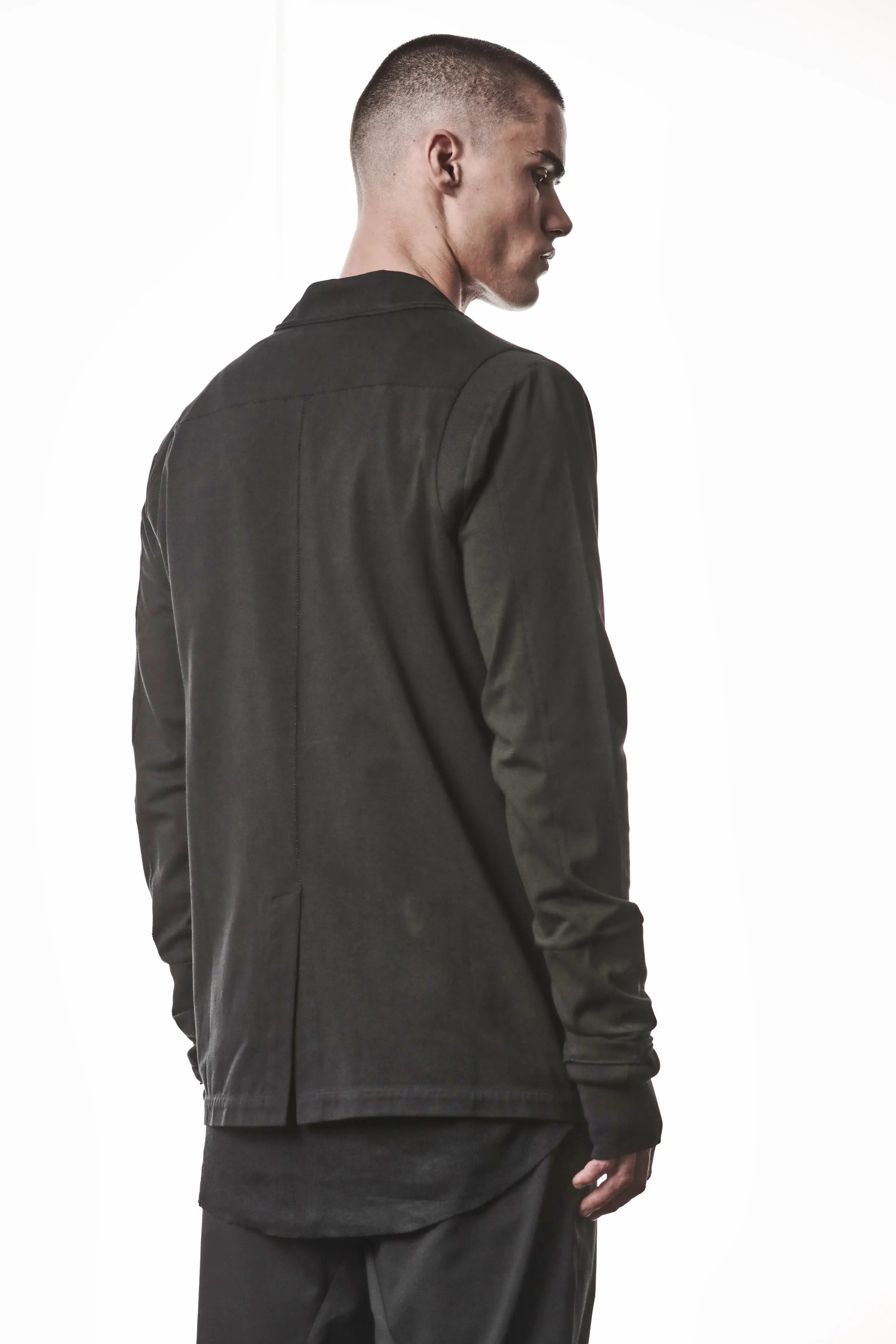 Thom Krom, Mens Blazer, Black, Shoulder Rib Patch, Thumbholes, 100% Cotton, Spandex, One Button, Thom Krom Button, Bellows Pockets, Long Sleeves, Regular Fit, Back 3/4 View. 