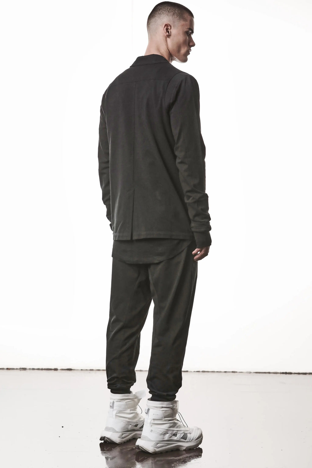 Thom Krom, Mens Blazer, Black, Shoulder Rib Patch, Thumbholes, 100% Cotton, Spandex, One Button, Thom Krom Button, Bellows Pockets, Long Sleeves, Regular Fit, Full Body Back 3/4 View. 