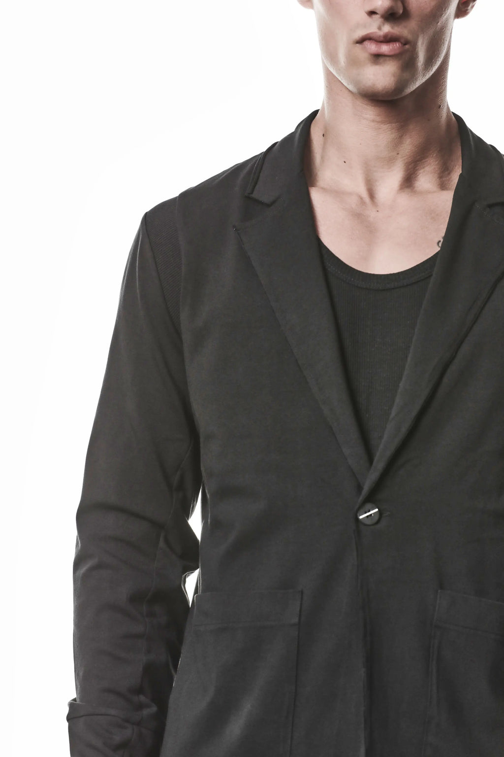Thom Krom, Mens Blazer, Black, Shoulder Rib Patch, Thumbholes, 100% Cotton, Spandex, One Button, Thom Krom Button, Bellows Pockets, Long Sleeves, Regular Fit, Closure Close-up. 