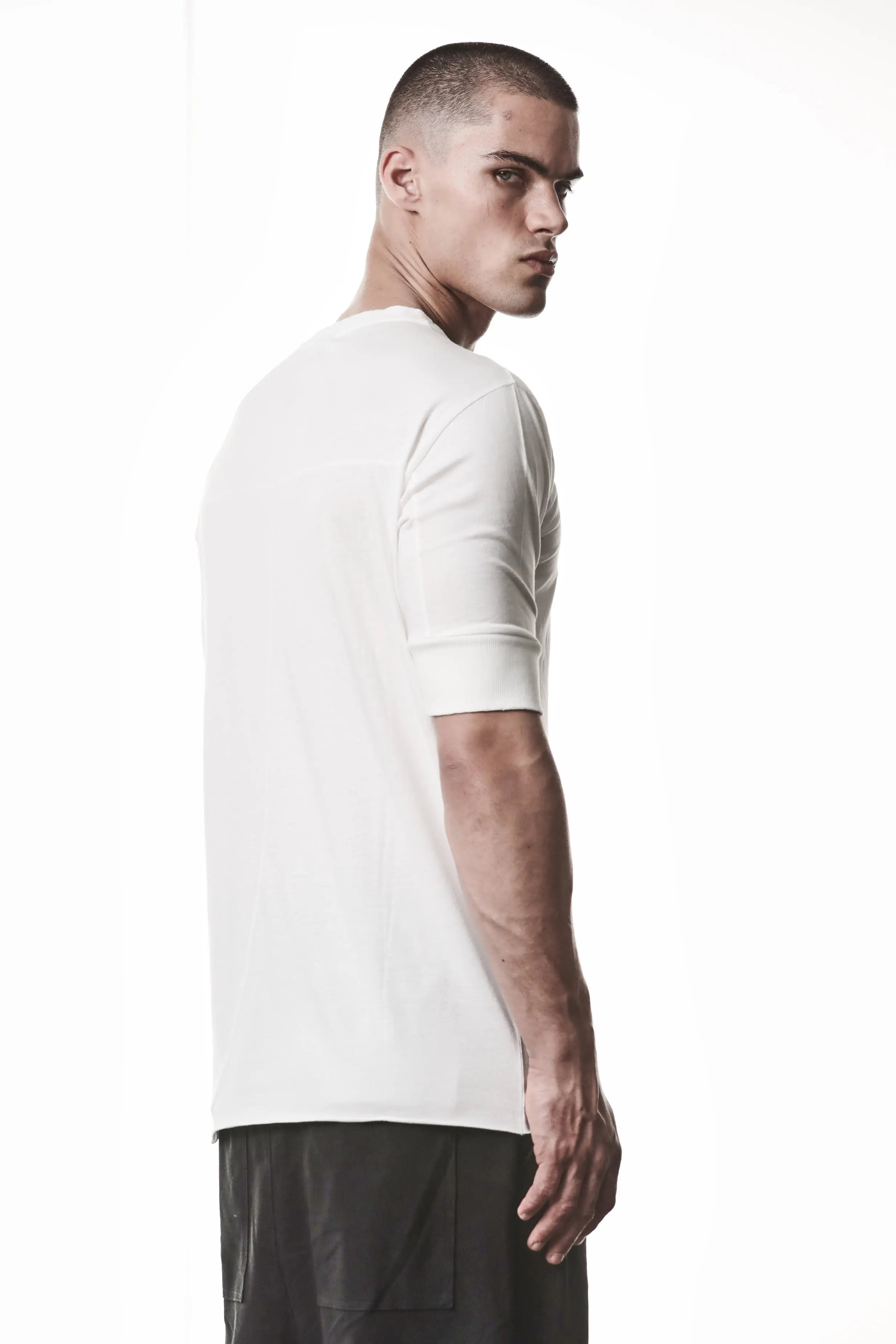 Thom Krom, Mens T-Shirt, Off-White, Cotton Modal Jersey, Ribbed Cuffs, Short Sleeves, Round Neck, Slim fit, Back Portrait 3/4 View. 